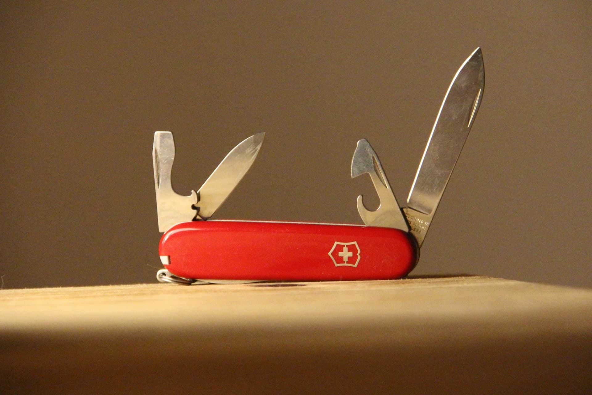 Red Swiss Army knife with blades and tools open, illustrating the versatility of specialist lending