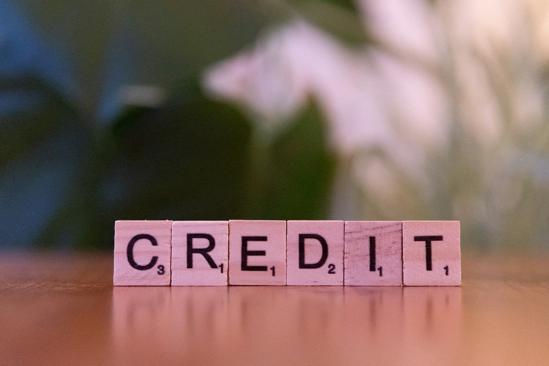 Credit letter tiles on a table representing bad credit and bridging loan eligibility