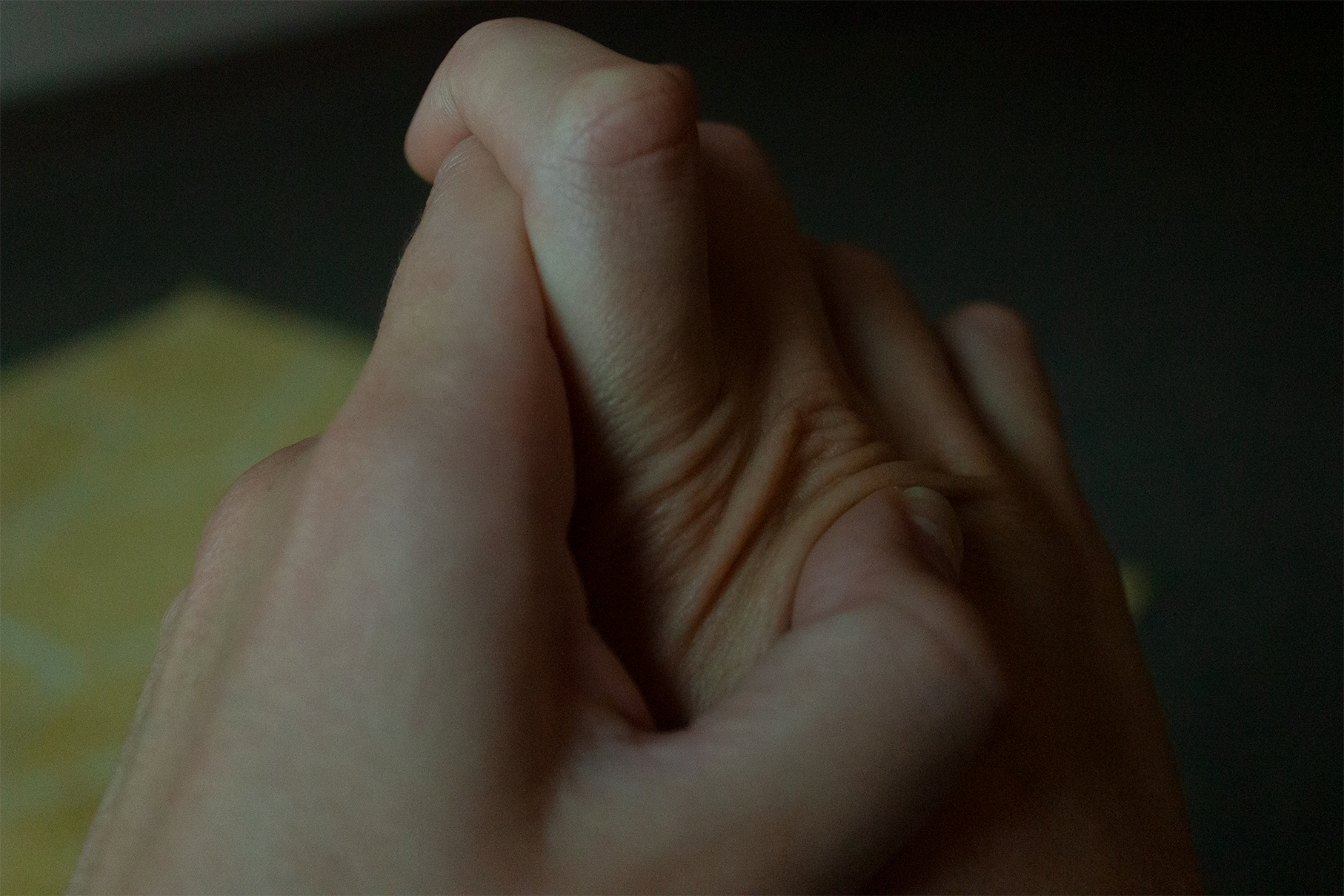 A digital photograph of my hands, where my fingers of my left hand are anxiously digging into the skin above my right hand's knuckles.