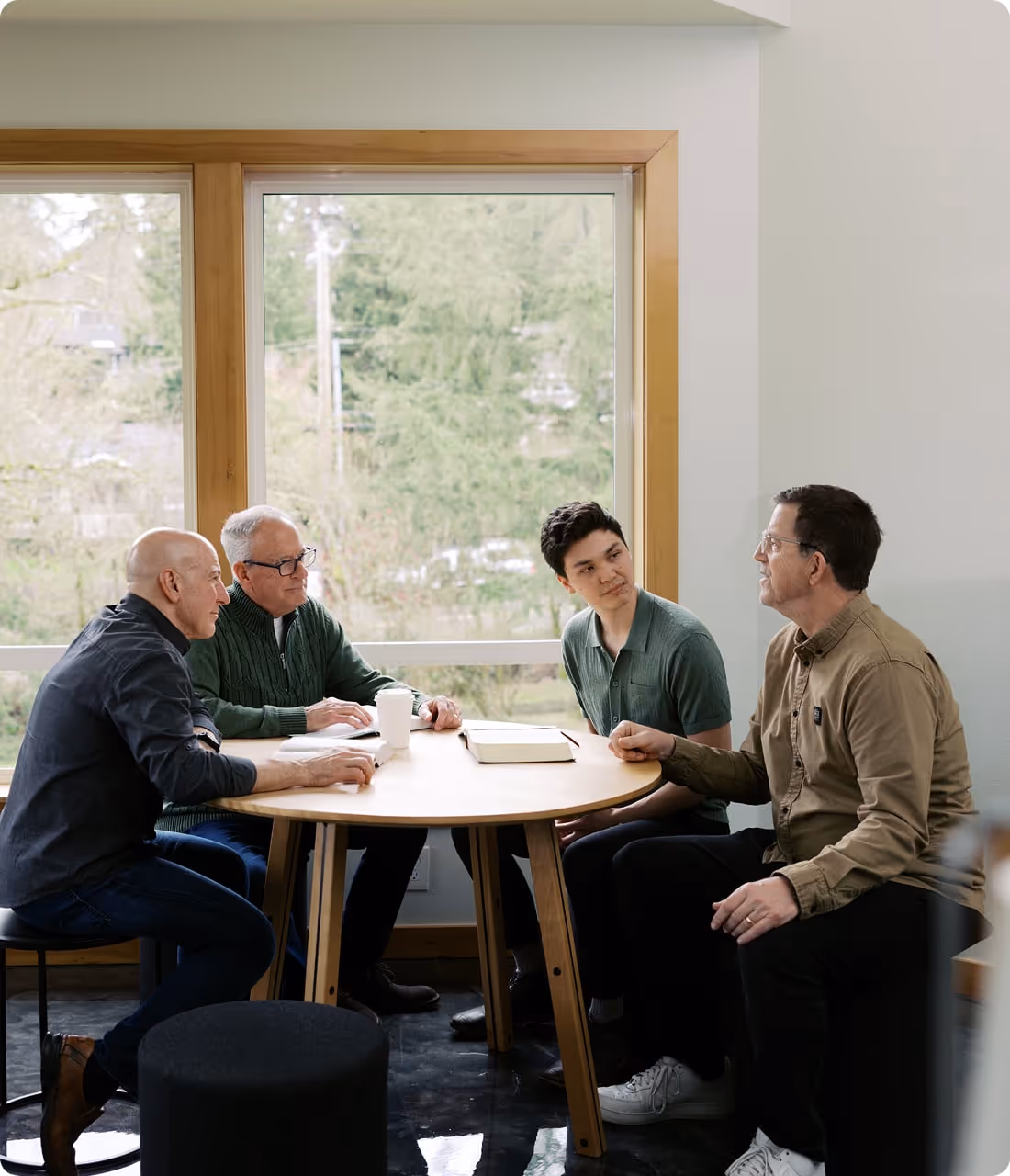 A group of men sitting around a table.