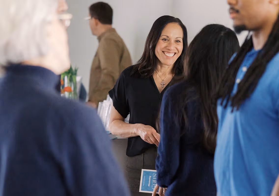 a woman greeting someone in the church lobby