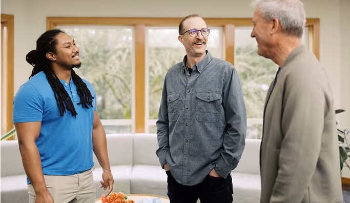 a group of men stand and talk