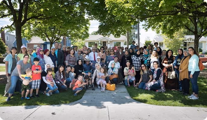 A large group stands outside for a picture. 