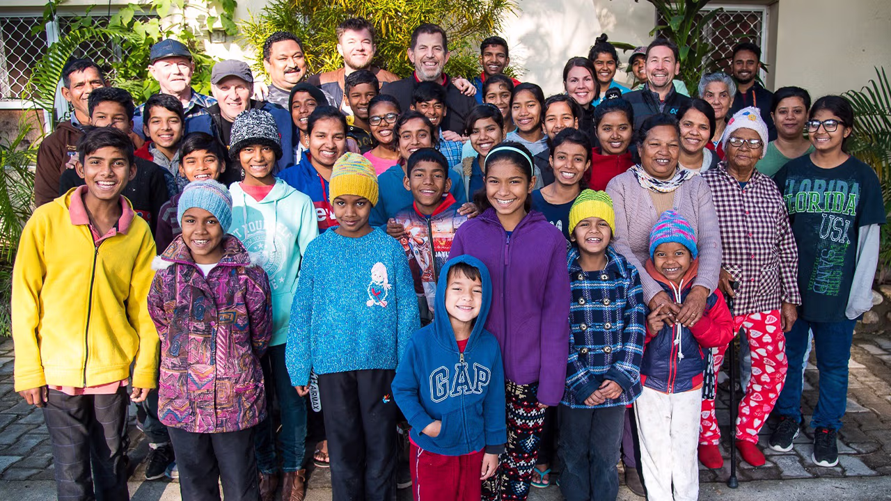 A group of children and adults in India