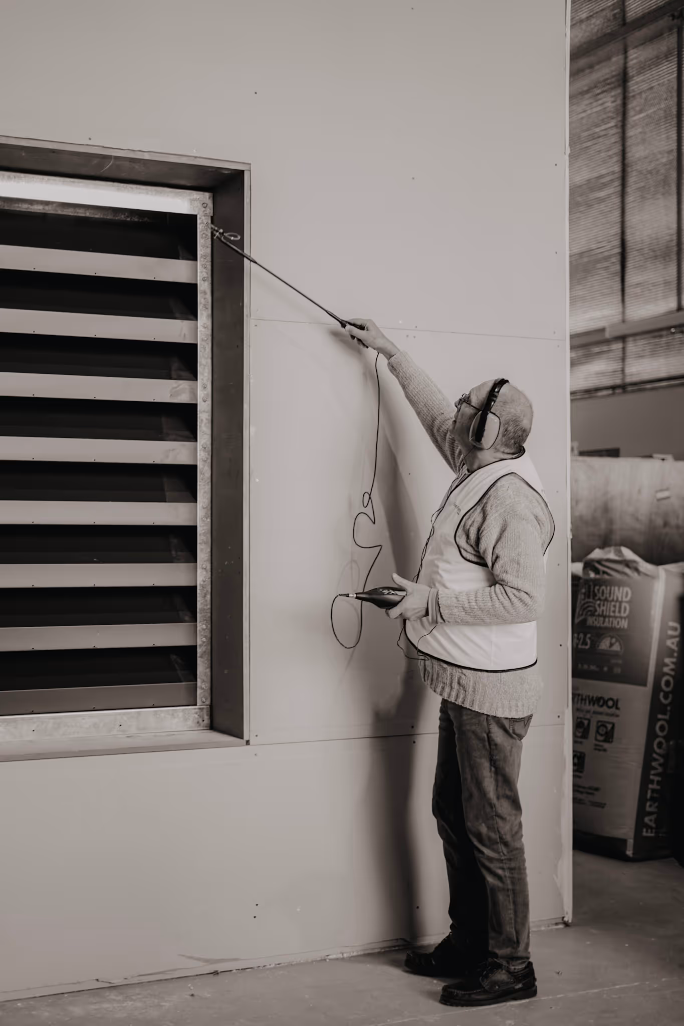 Con-form engineer performing testing for rooftop sound absorption
