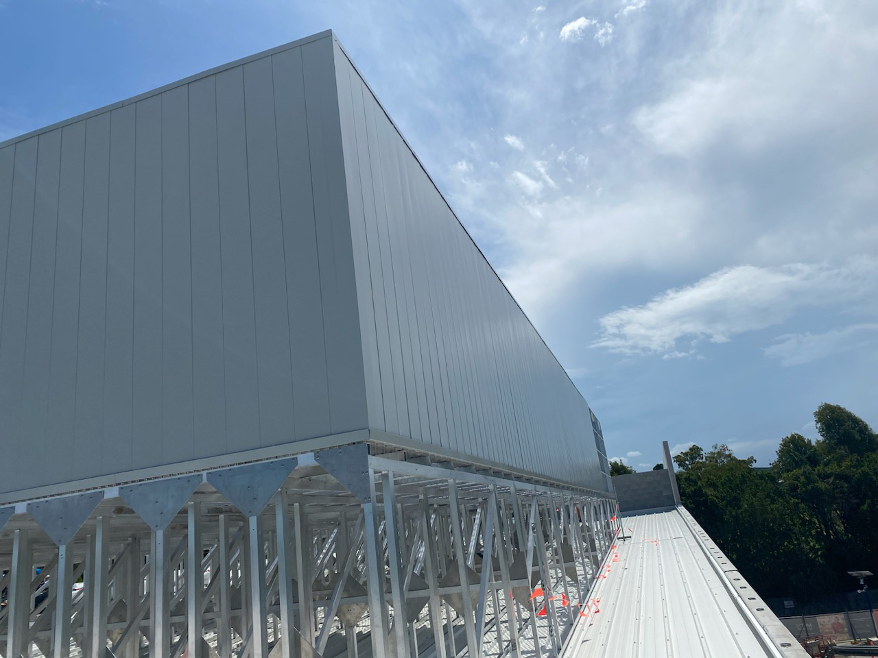 Grey data centre enclosure mounted above a rooftop access platform.