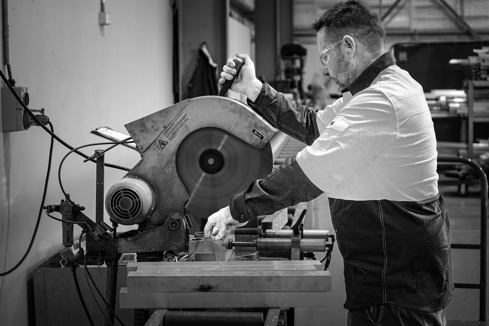 Con-form engineer operating mitre saw