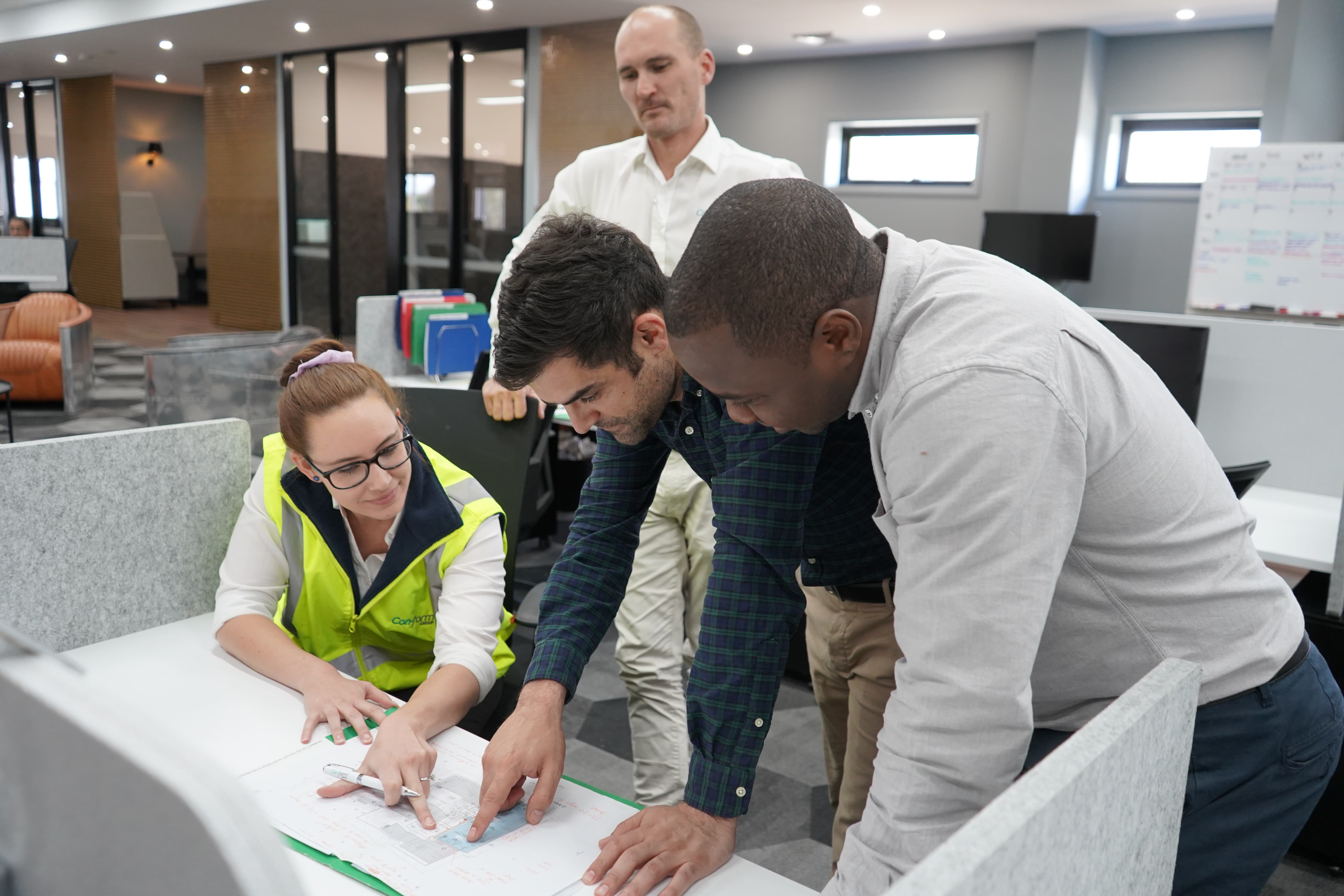 Engineers discussing rooftop construction plan