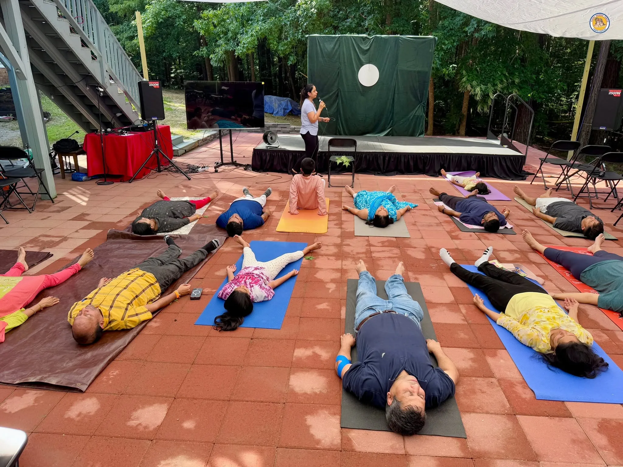 Yoga Nidra relaxation session with participants on mats outdoors at NC Yoga Fest