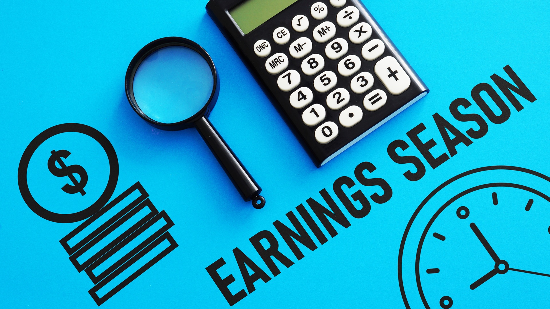 Earnings season concept image with a calculator and magnifying glass on a blue background