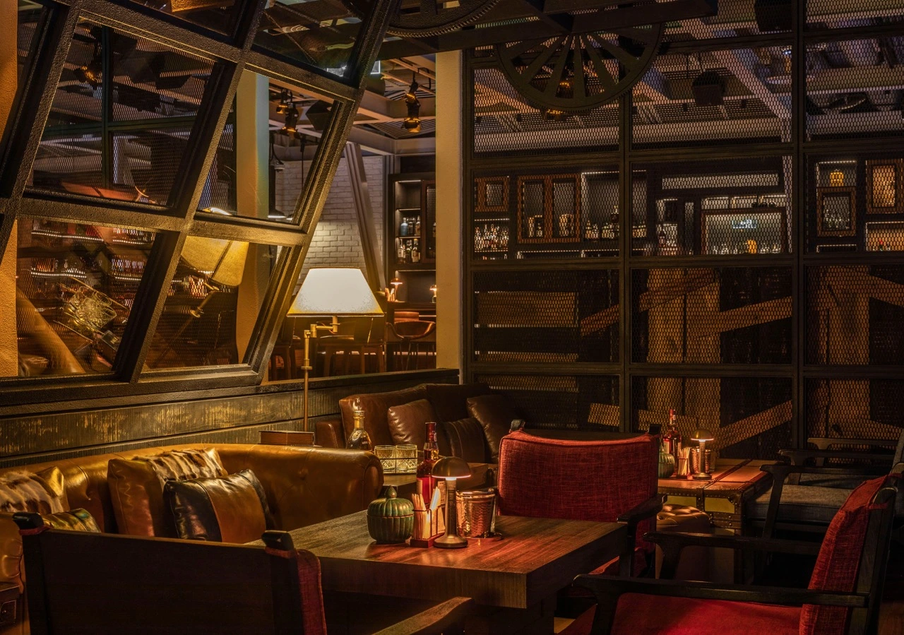 dim shot of the seating area with warm lights of prohibition bar at mandarin oriental shenzhen