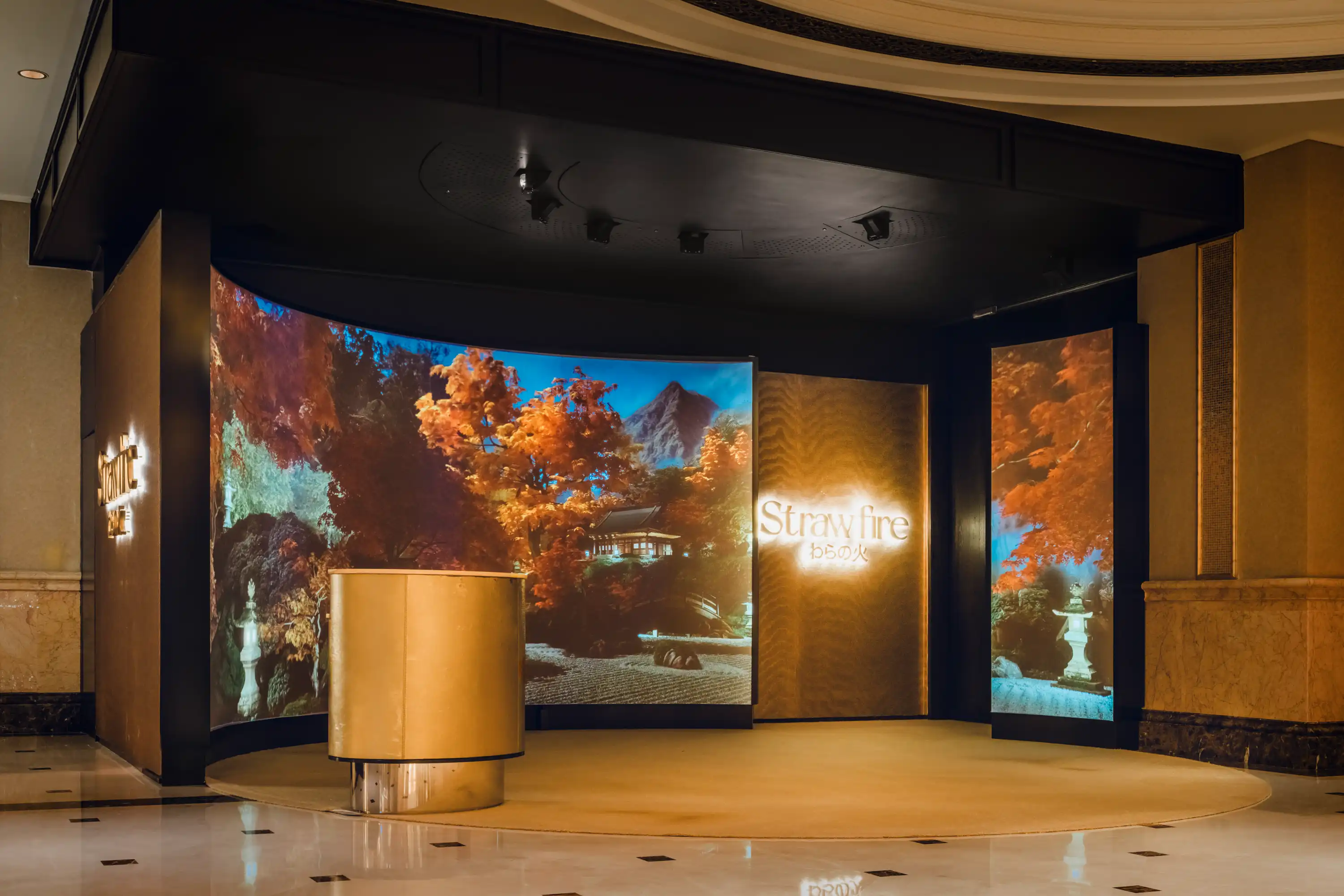Strawfire restaurant entrance at Emirates Palace Abu Dhabi featuring an immersive curved digital screen.