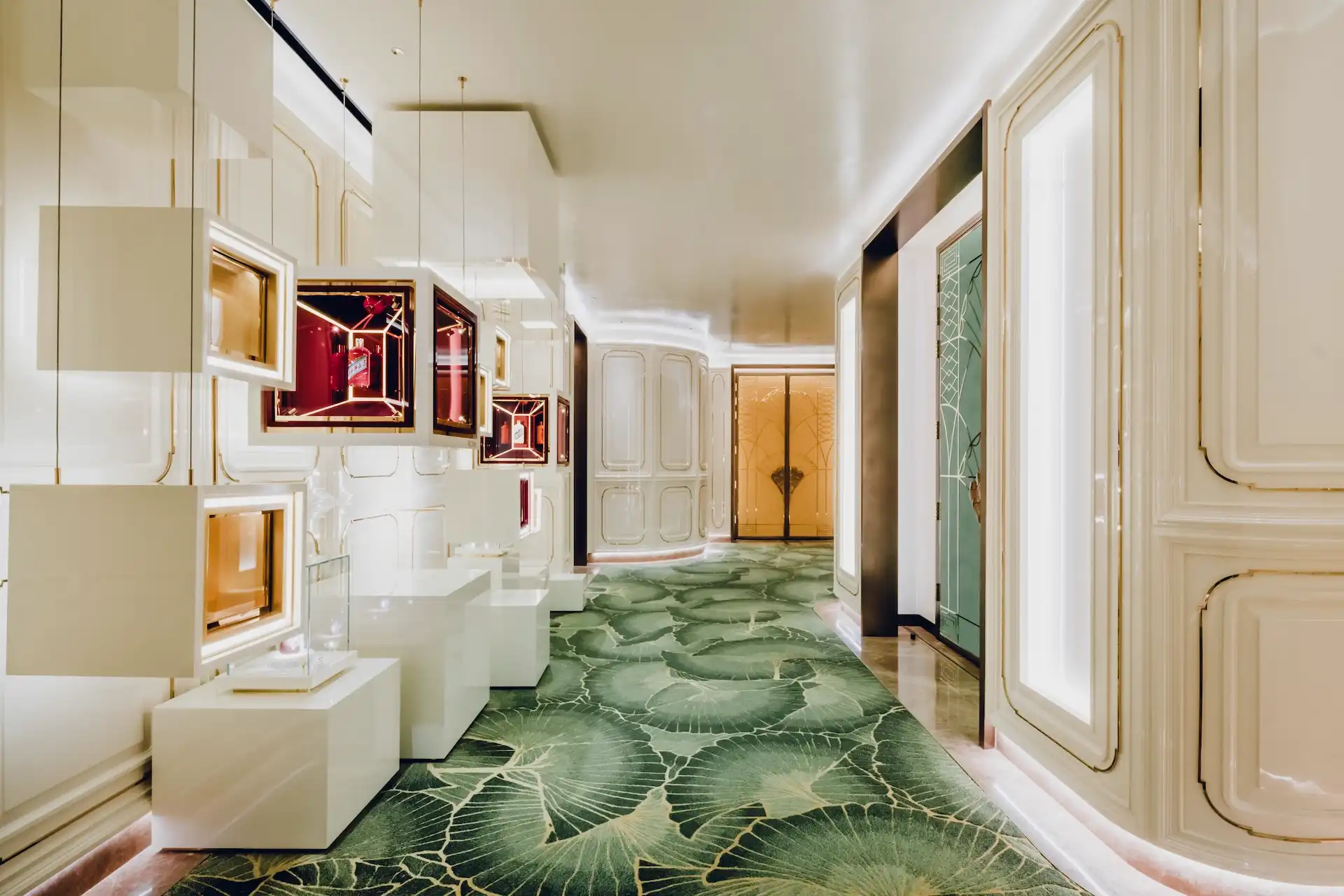 Grand Imperial Court corridor at MGM Macao featuring illuminated Moutai display boxes mirrored wall panels bespoke leaf patterned carpet and ivory classical detailing within a luxury Chinese restaurant interior