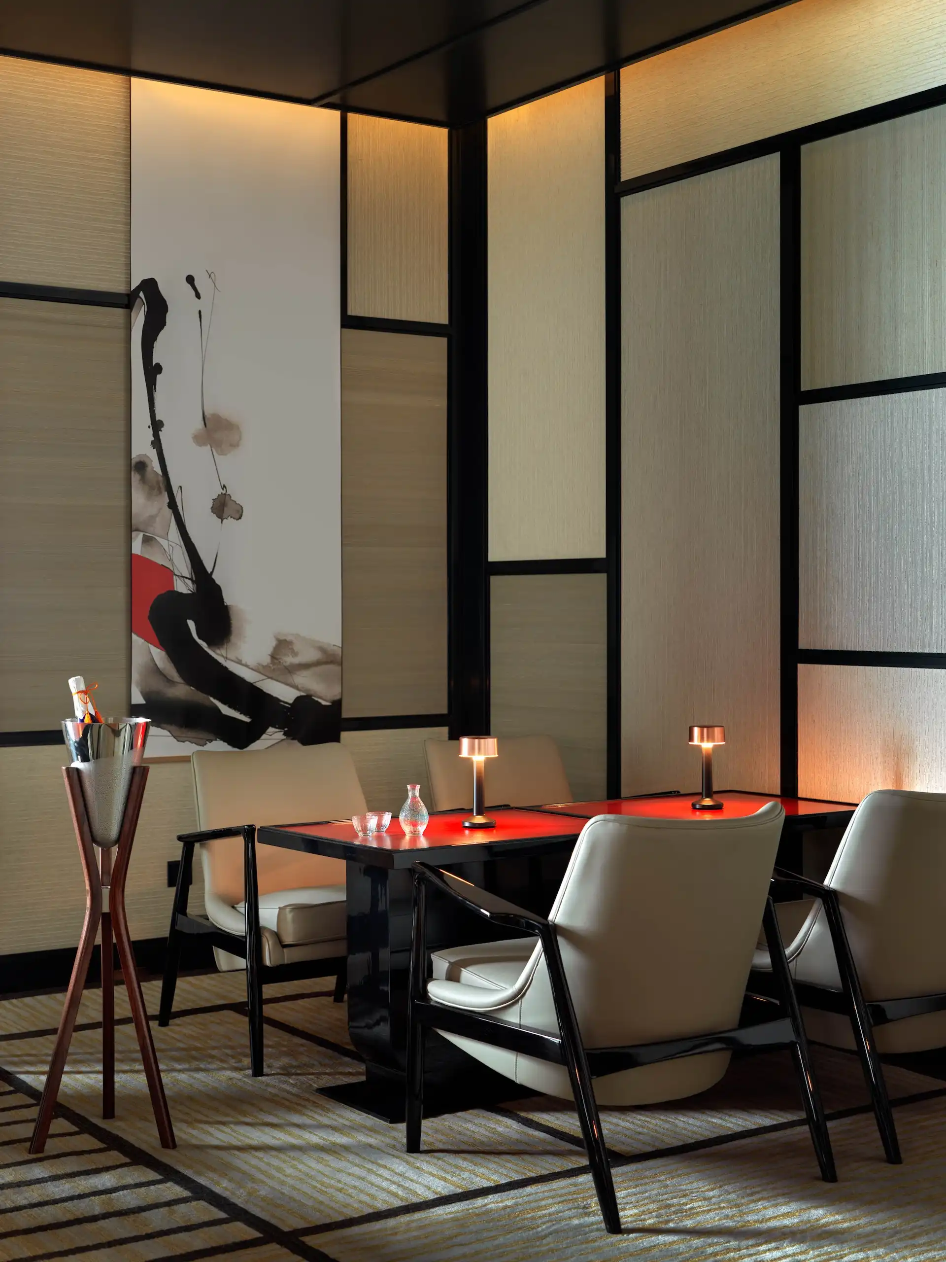 Intimate dining setting at RIN Mandarin Oriental Shenzhen featuring red lacquer dining table, upholstered chairs with black frames, Japanese inspired wall panels and contemporary artwork within a refined private dining environment.