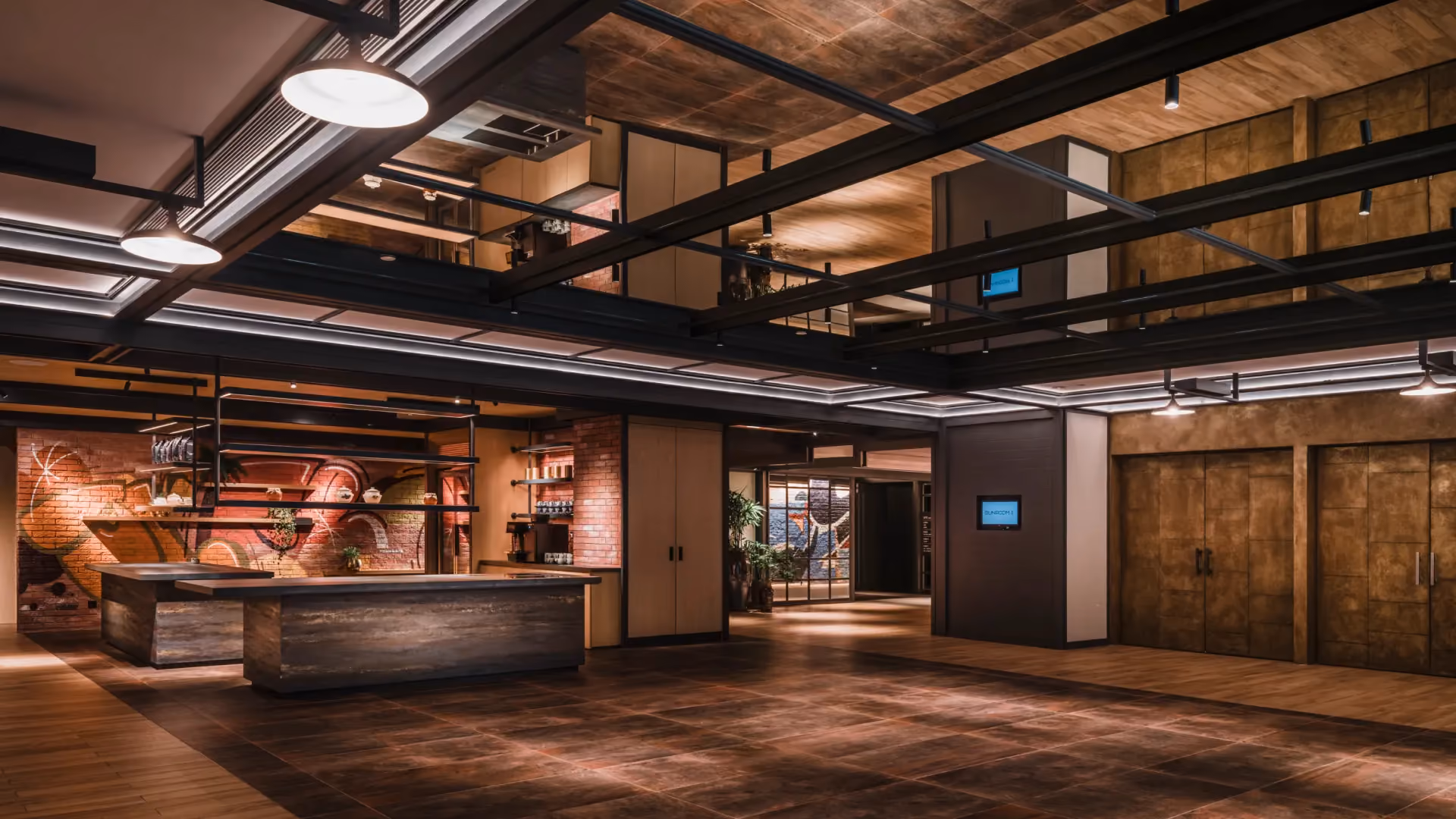 Level 1 breakout area at Hyatt Centric City Centre Kuala Lumpur, with rusted iron kitchen blocks, steel gantries and graffiti artwork