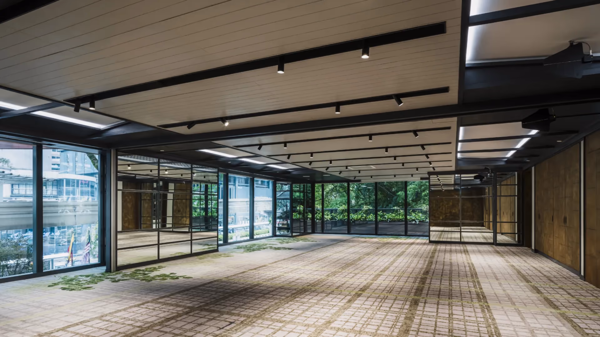 Level 1 pre-function area at Hyatt Centric City Centre Kuala Lumpur, with mirrored window frames, track lighting and green-flecked carpet