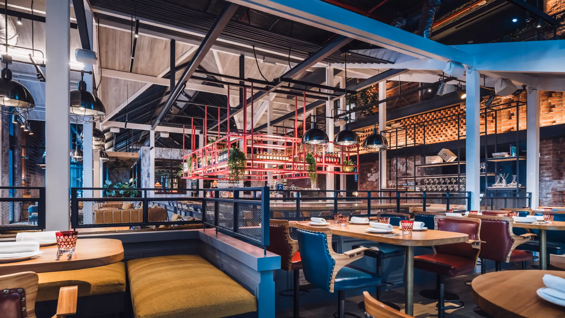 The Foundry at IL Forno, Hyatt Centric City Centre Kuala Lumpur, with blue and mustard banquettes, communal tables and exposed steel structure
