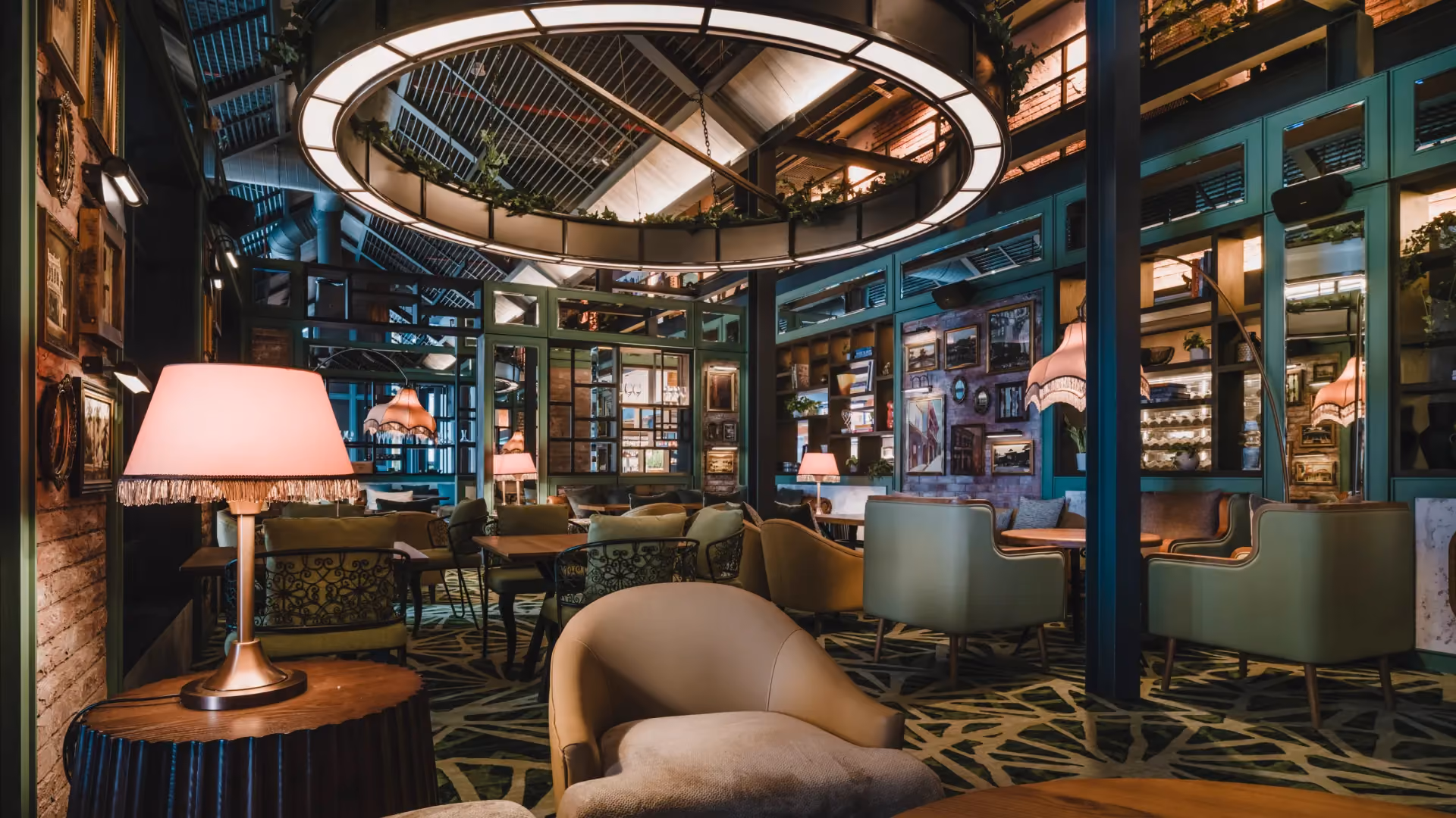 The Forge at IL Forno, Hyatt Centric City Centre Kuala Lumpur, with soft lounge chairs, a pink table lamp, teal steel framing and a circular ceiling light