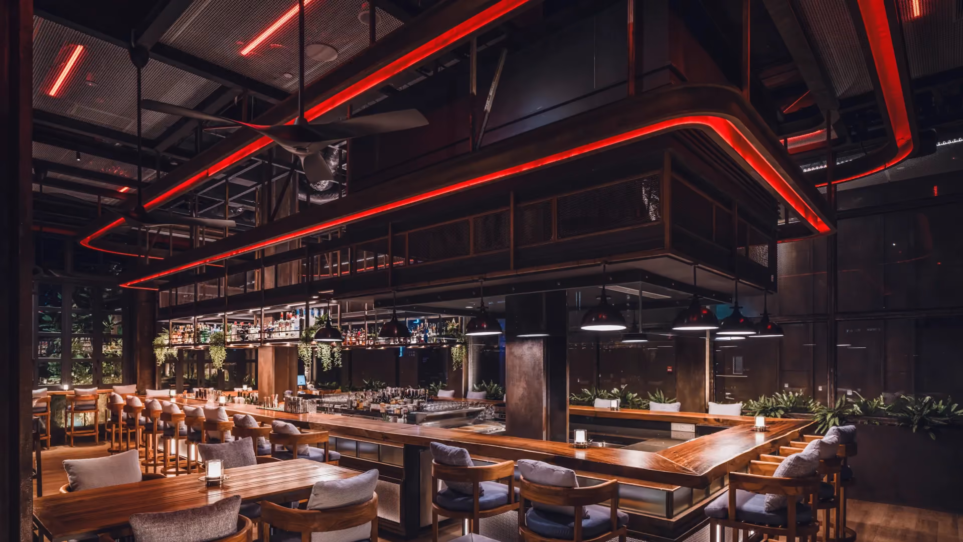 @21 Sky Bar at Hyatt Centric City Centre Kuala Lumpur, with a long live edge timber counter under a red-lit perforated steel gantry