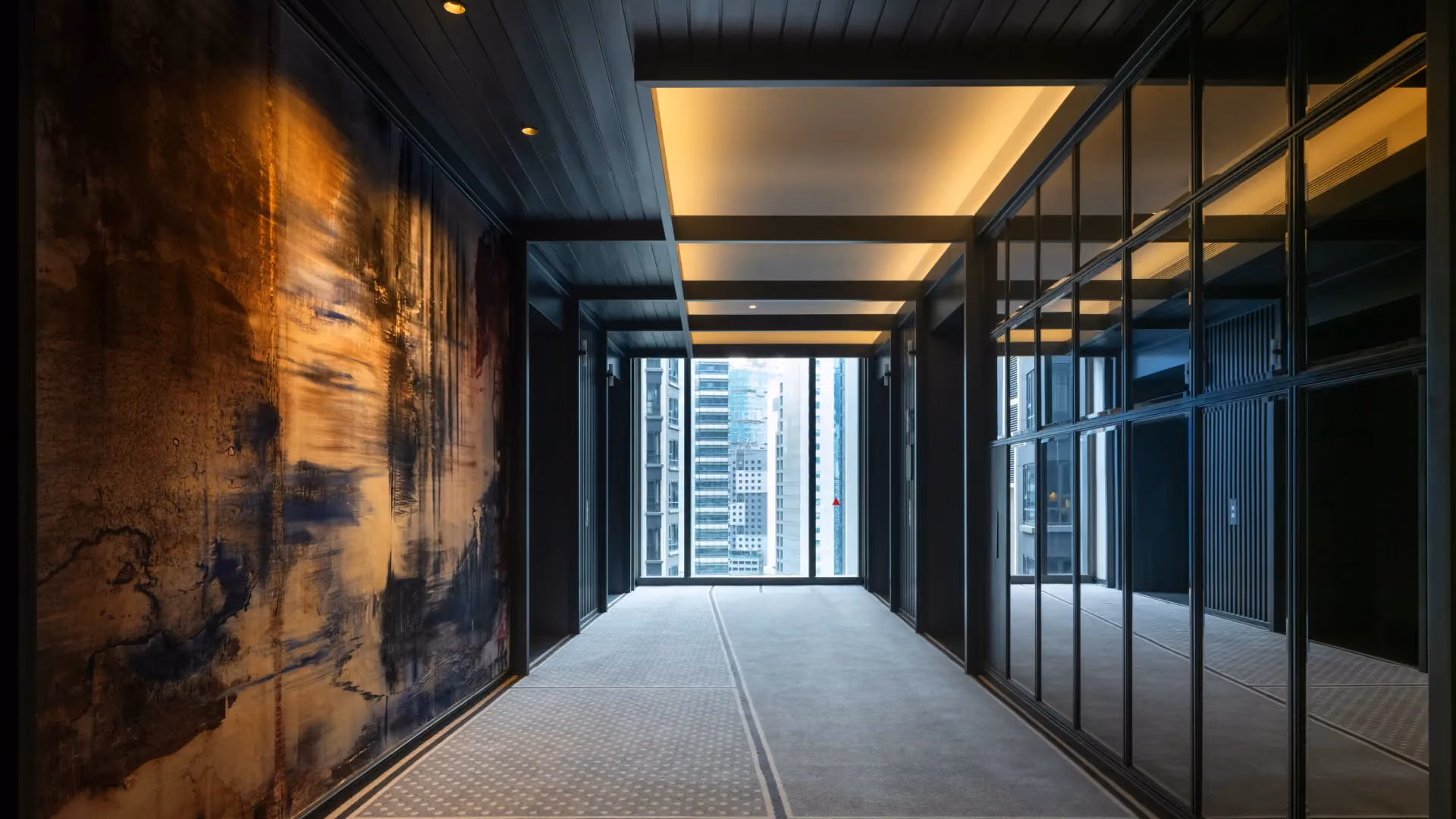 Guestroom lift lobby at Hyatt Centric City Centre Kuala Lumpur, with a large textured mural, steel-framed glass panels and city views