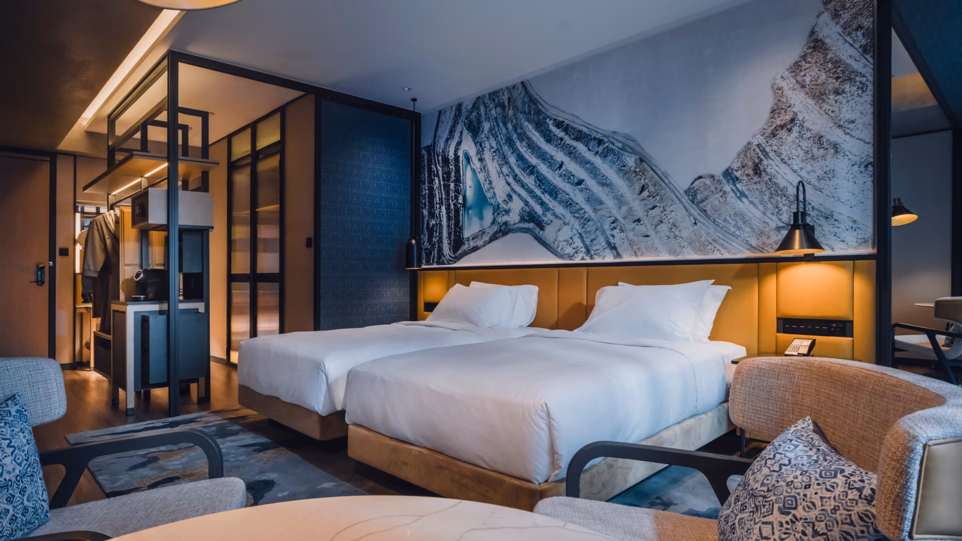 Standard Twin guestroom at Hyatt Centric City Centre Kuala Lumpur, with a tin mine mural, leather headboard, lounge chairs and a hand tufted rug