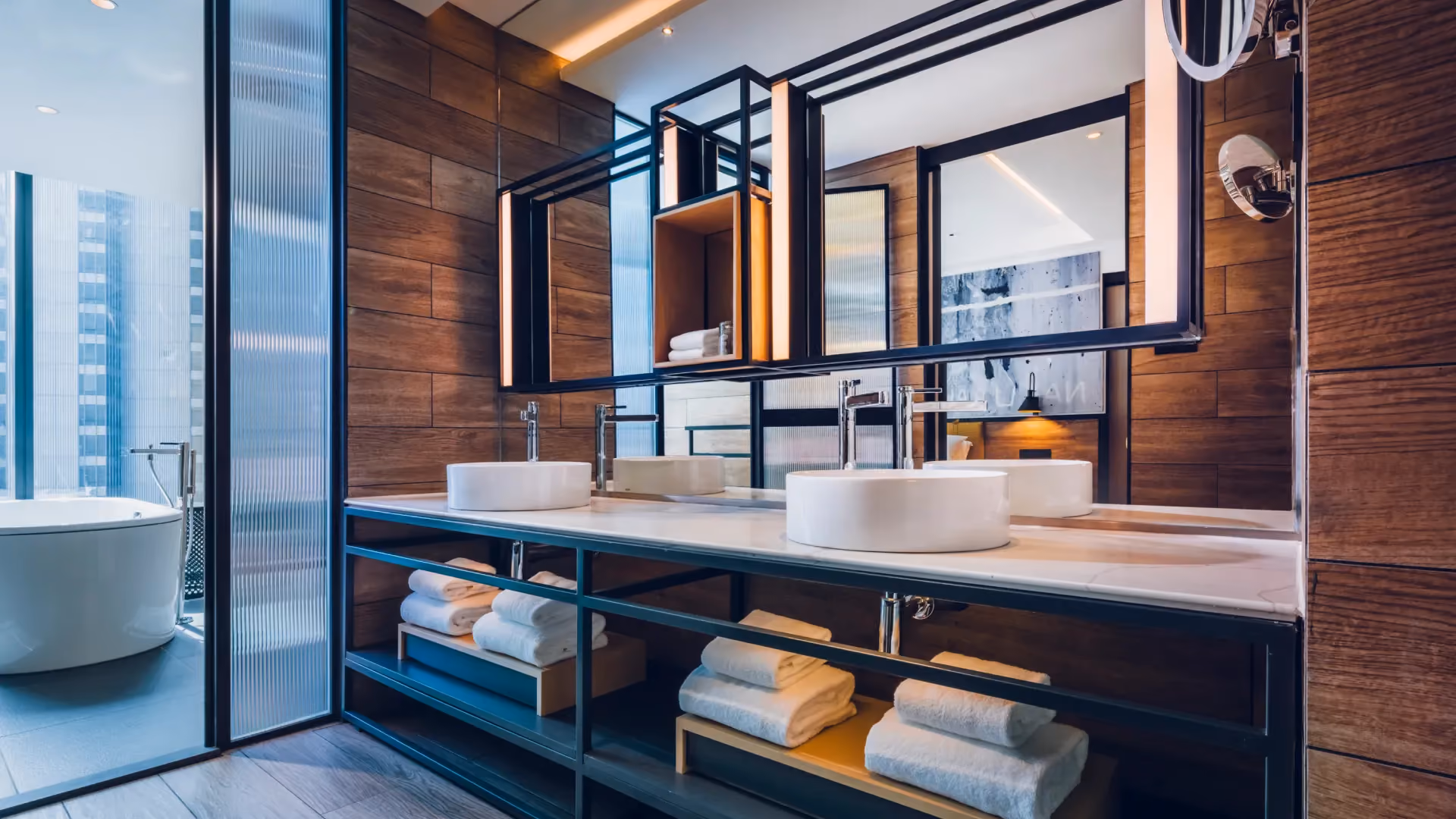 Hospitality Suite bathroom at Hyatt Centric City Centre Kuala Lumpur, with twin basins, steel-framed mirrors, timber walls and city views