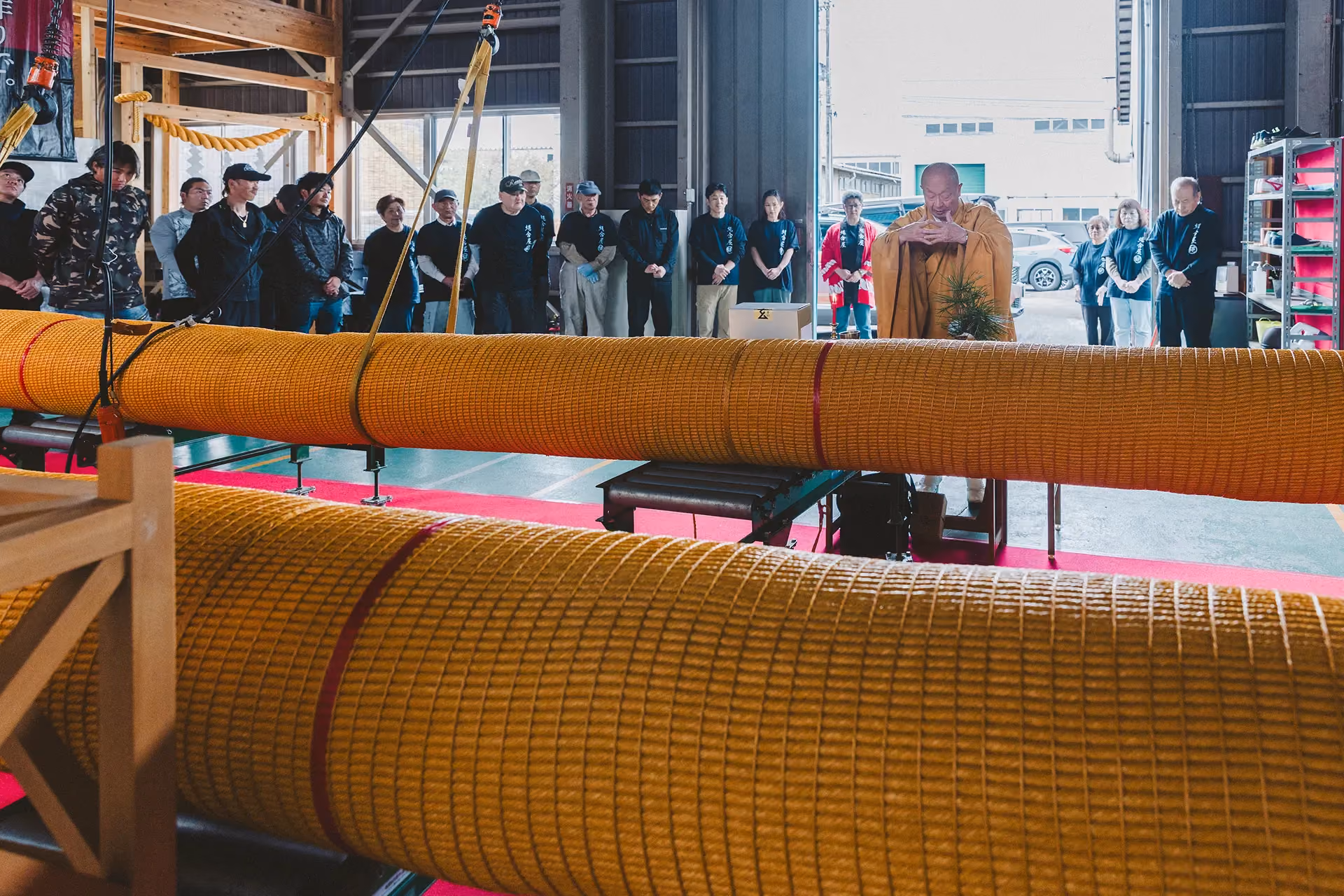 Blessing ceremony for the Shimenawa rope made for Strawfire, with the rope sections laid out in a workshop