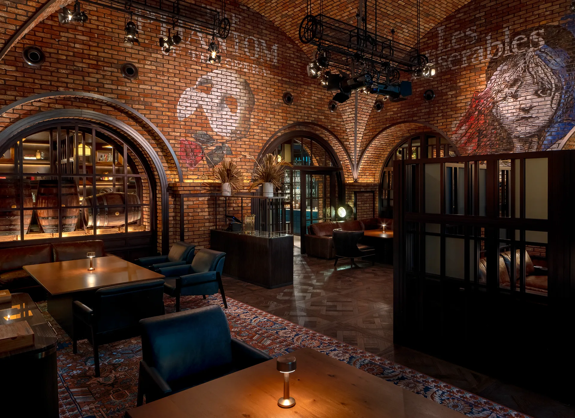 The Cellar lounge at Broadway, Emirates Palace Abu Dhabi, with a brick-vaulted ceiling painted with theatre ghost art, stage lighting rigs and lounge seating