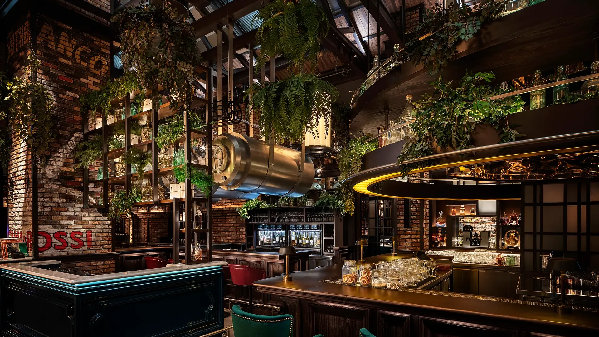 Main bar at Broadway, Emirates Palace Abu Dhabi, with an inverted copper barrel, beer taps, hanging greenery and teal bar seating