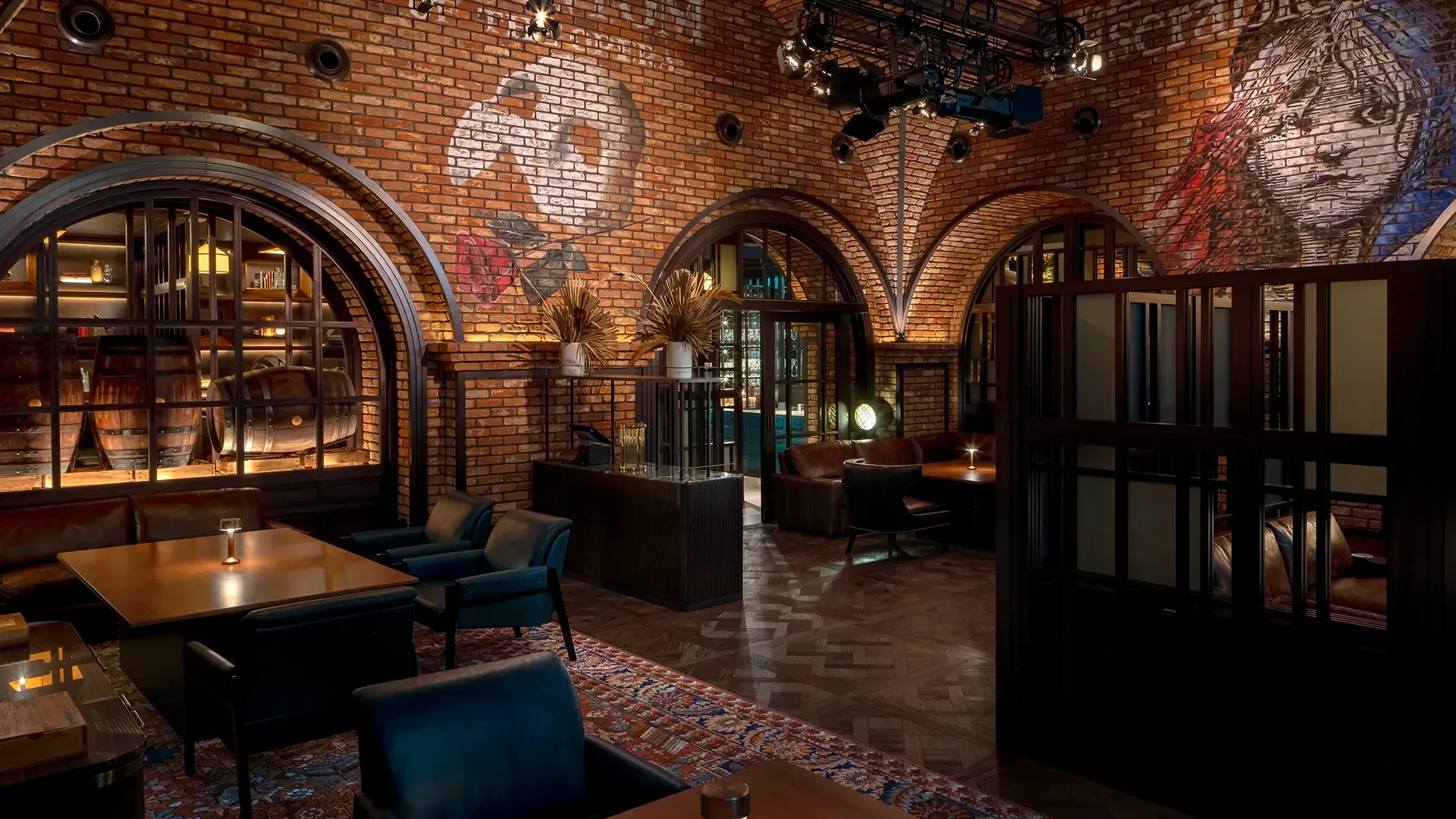 The Cellar lounge at Broadway, Emirates Palace Abu Dhabi, with a brick-vaulted ceiling painted with theatre ghost art, stage lighting rigs and lounge seating