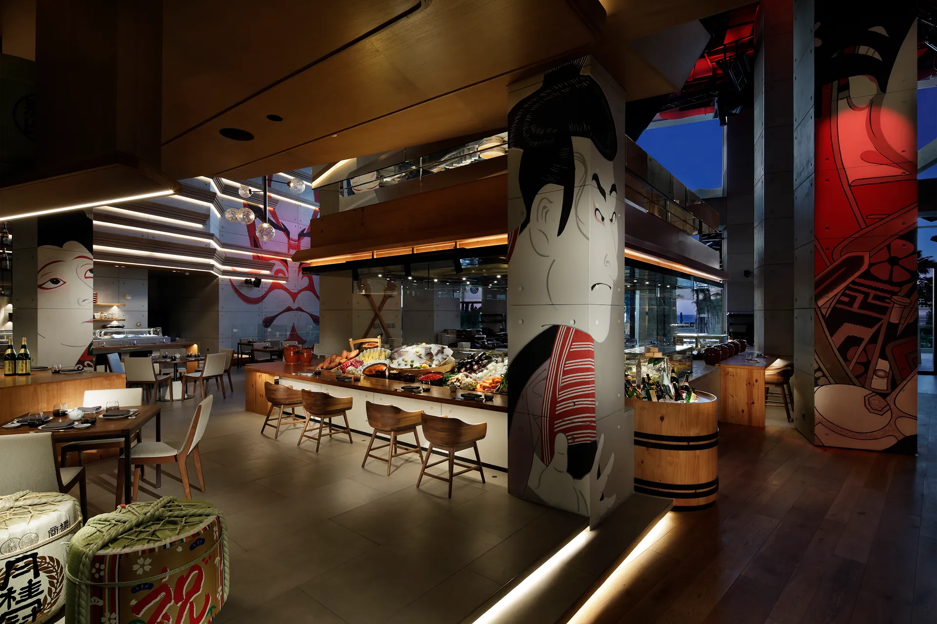 Main dining area at Netsu, Mandarin Oriental Jumeira Dubai, with kabuki poster graphics on the columns, a raw ingredient display counter and timber bar stools