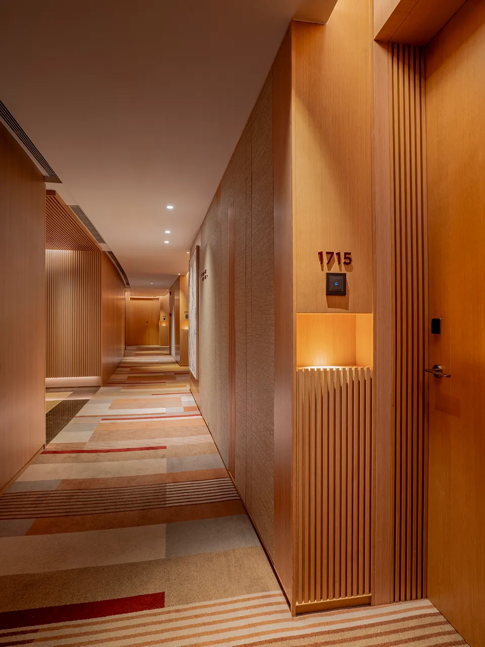 Guestroom corridor at Hyatt Regency Hengqin with warm timber walls