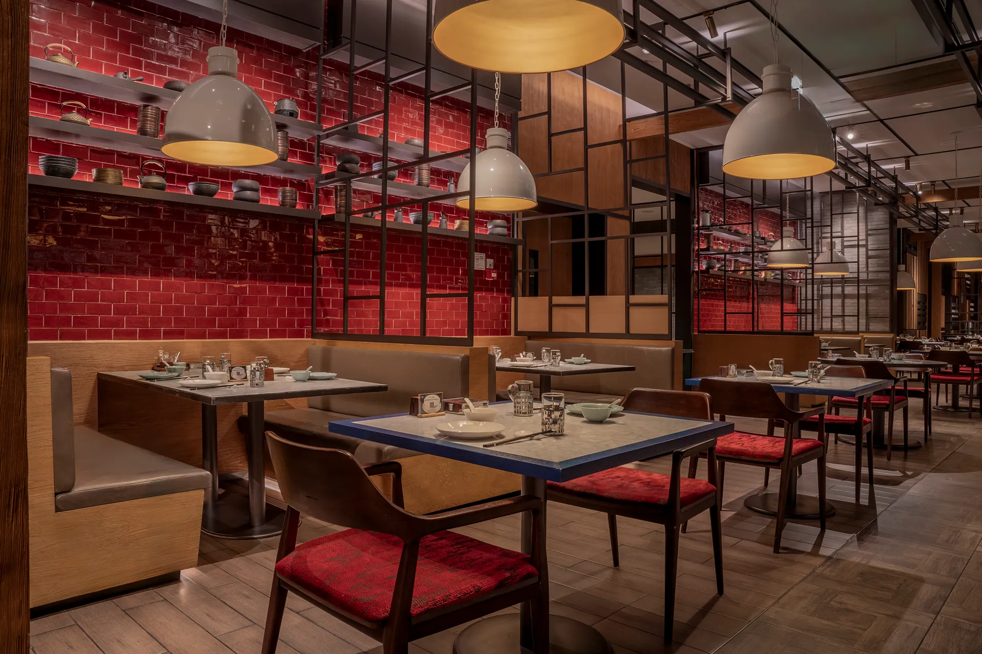 Dining area of Xiang Yue Chinese restaurant at Hyatt Regency Hengqin with red tiled feature wall