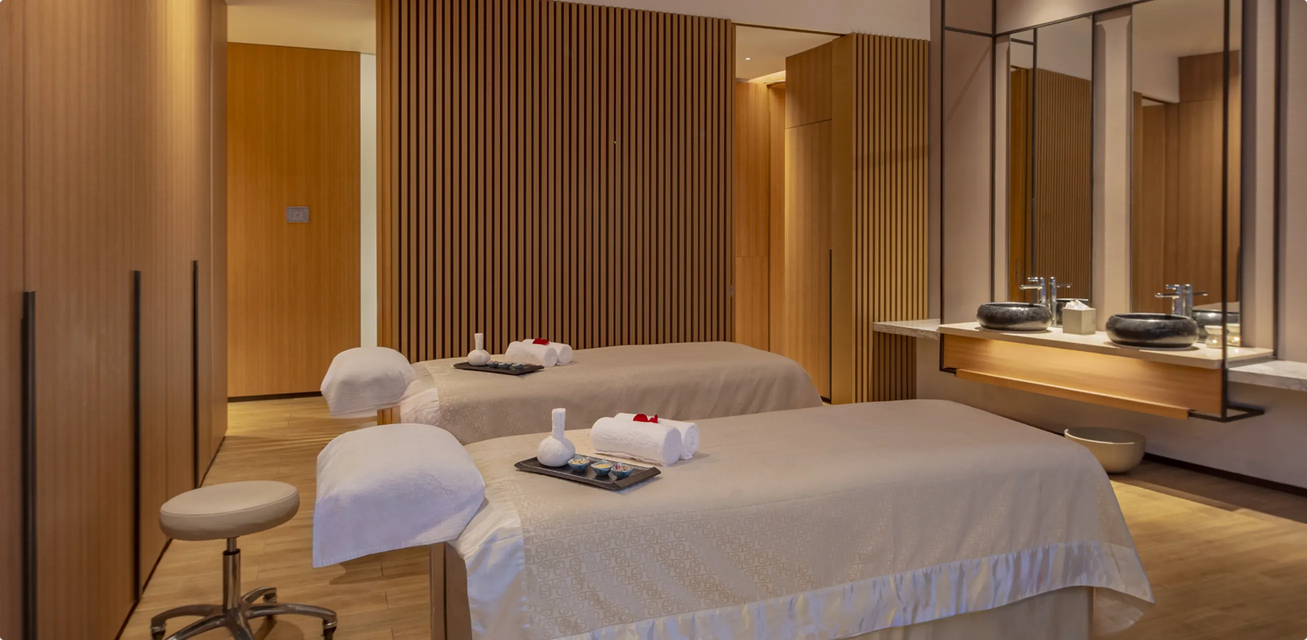 Spa treatment room at Hyatt Regency Hengqin with paired treatment beds and timber finishes