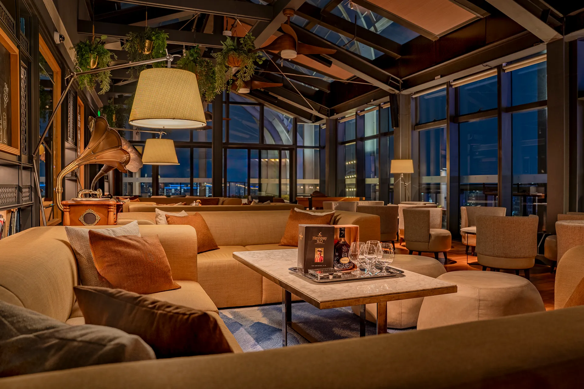 Lounge seating at The Loft rooftop bar, Hyatt Regency Hengqin, with club sofas and pendant lights