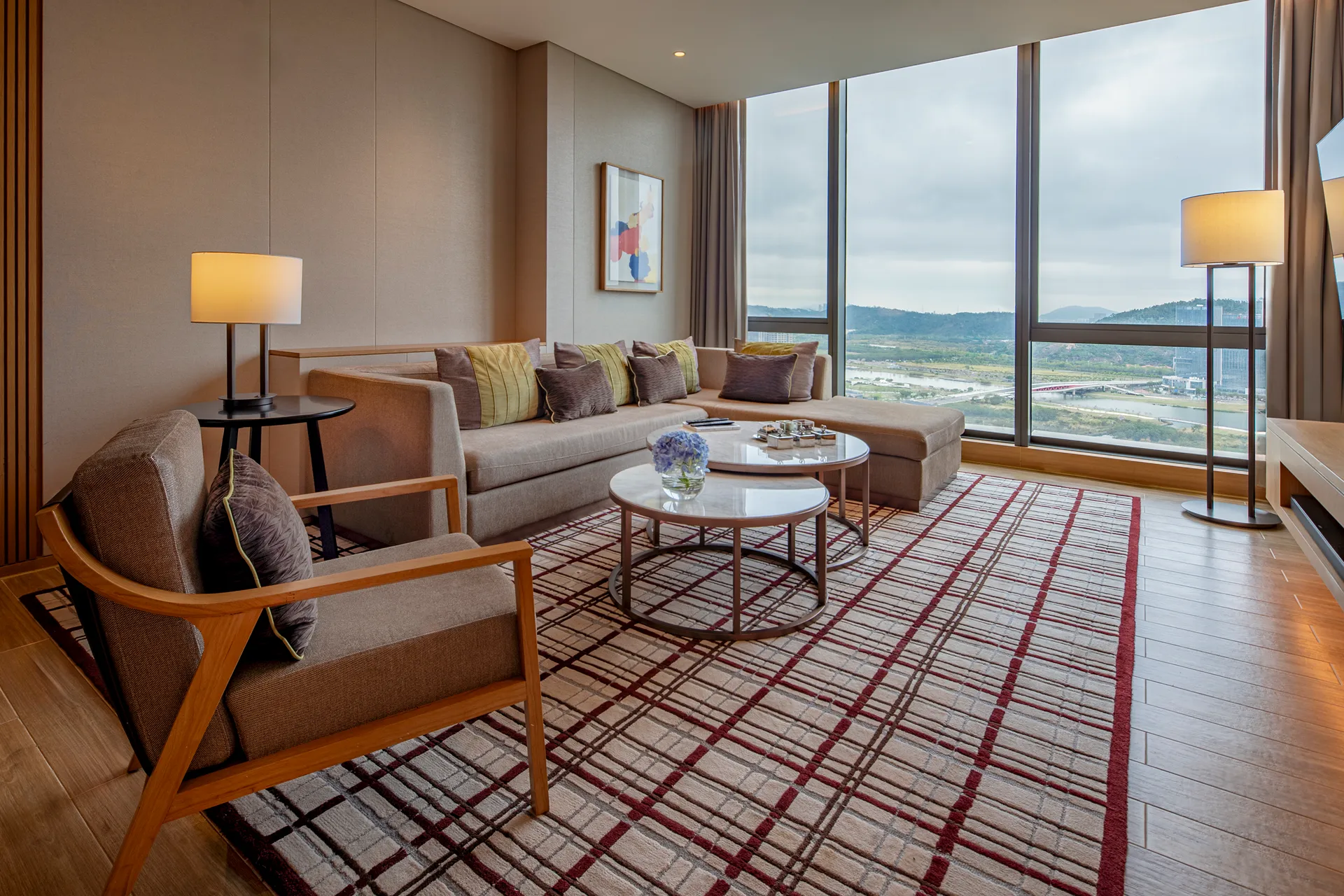 Executive suite living area at Hyatt Regency Hengqin with sofa seating and a patterned rug