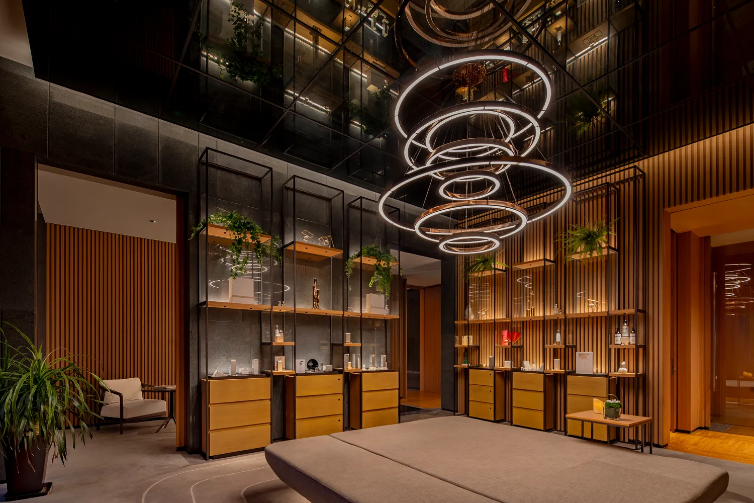 Spa reception at Hyatt Regency Hengqin with concentric ring pendants and timber shelving