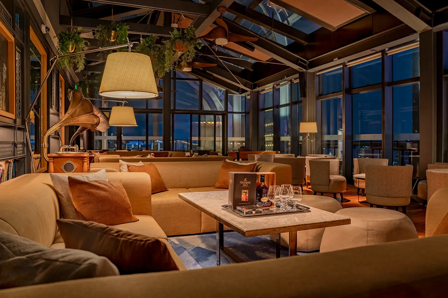 Lounge seating at The Loft rooftop bar, Hyatt Regency Hengqin, with club sofas and city views