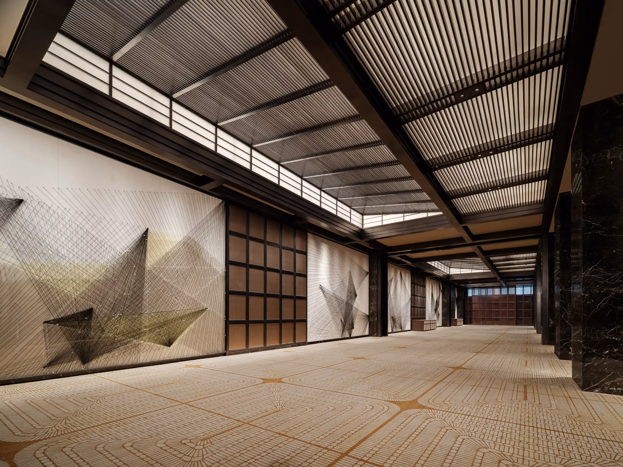 Pre-function corridor at Thompson Shanghai Expo with timber panelling and a textured feature wall