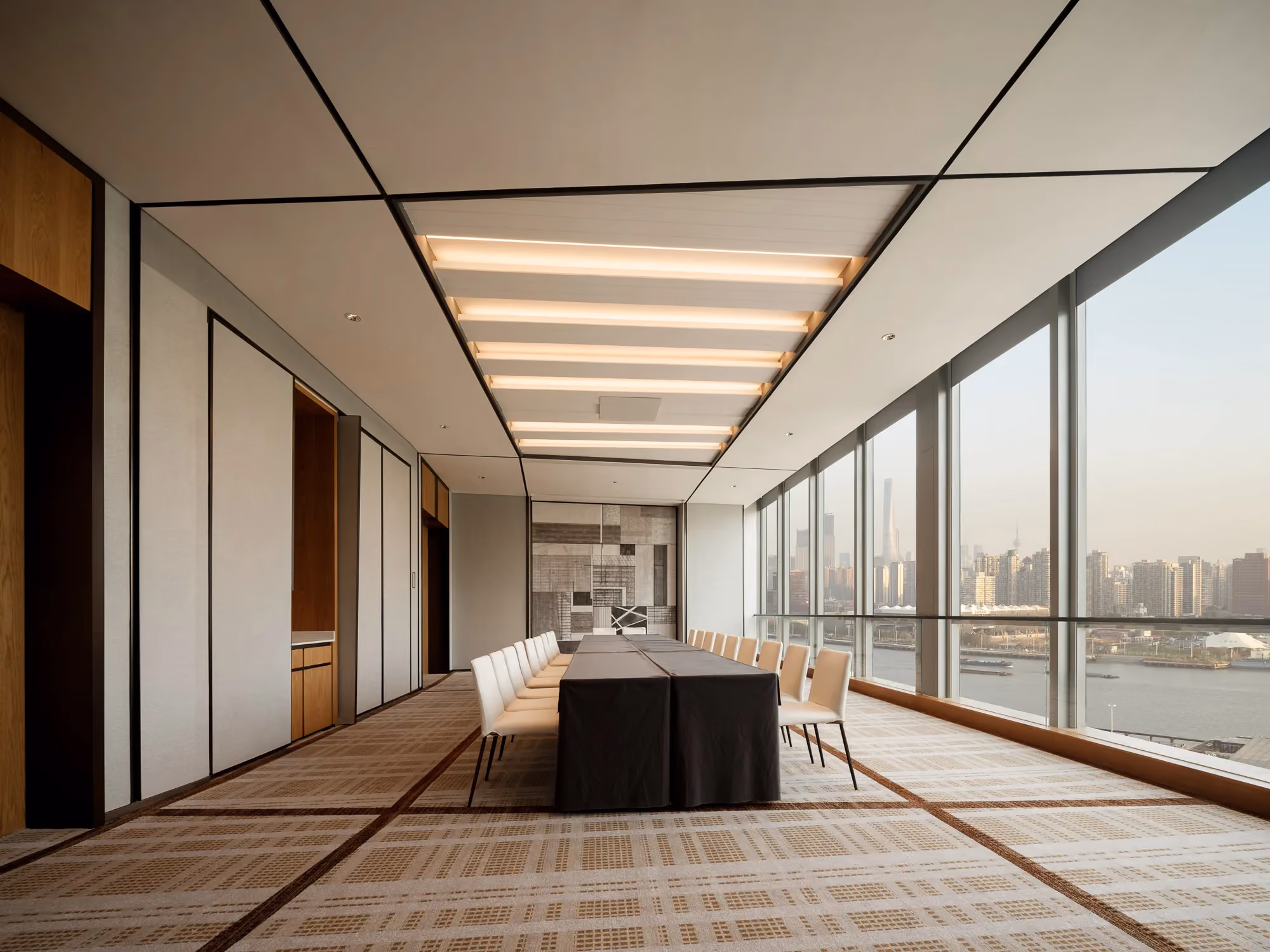 Meeting room at Thompson Shanghai Expo with floor-to-ceiling windows and river views