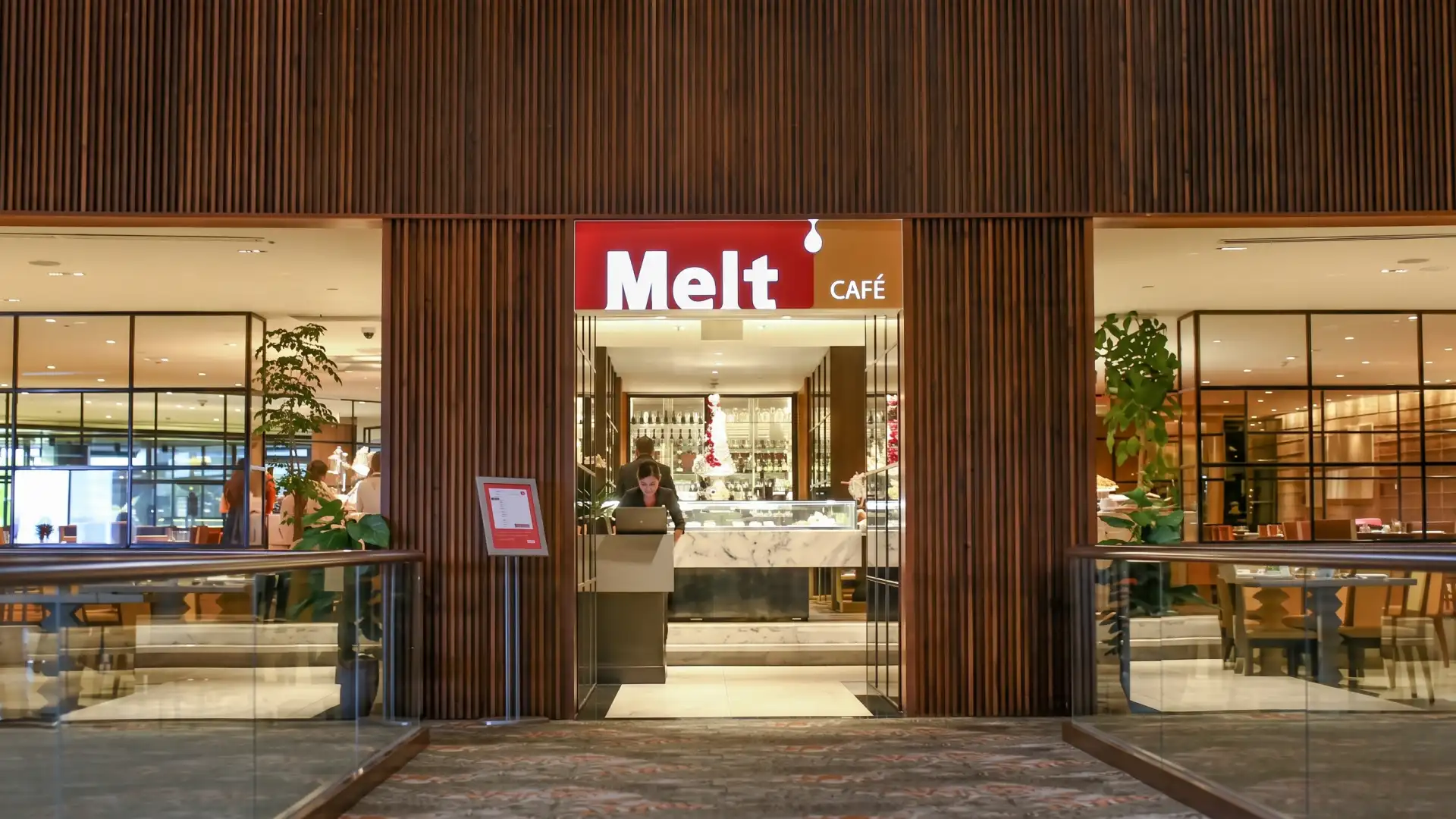 Former Melt Cafe entrance at Mandarin Oriental, Singapore, with timber slat cladding and glass balustrades, before embu replaced it