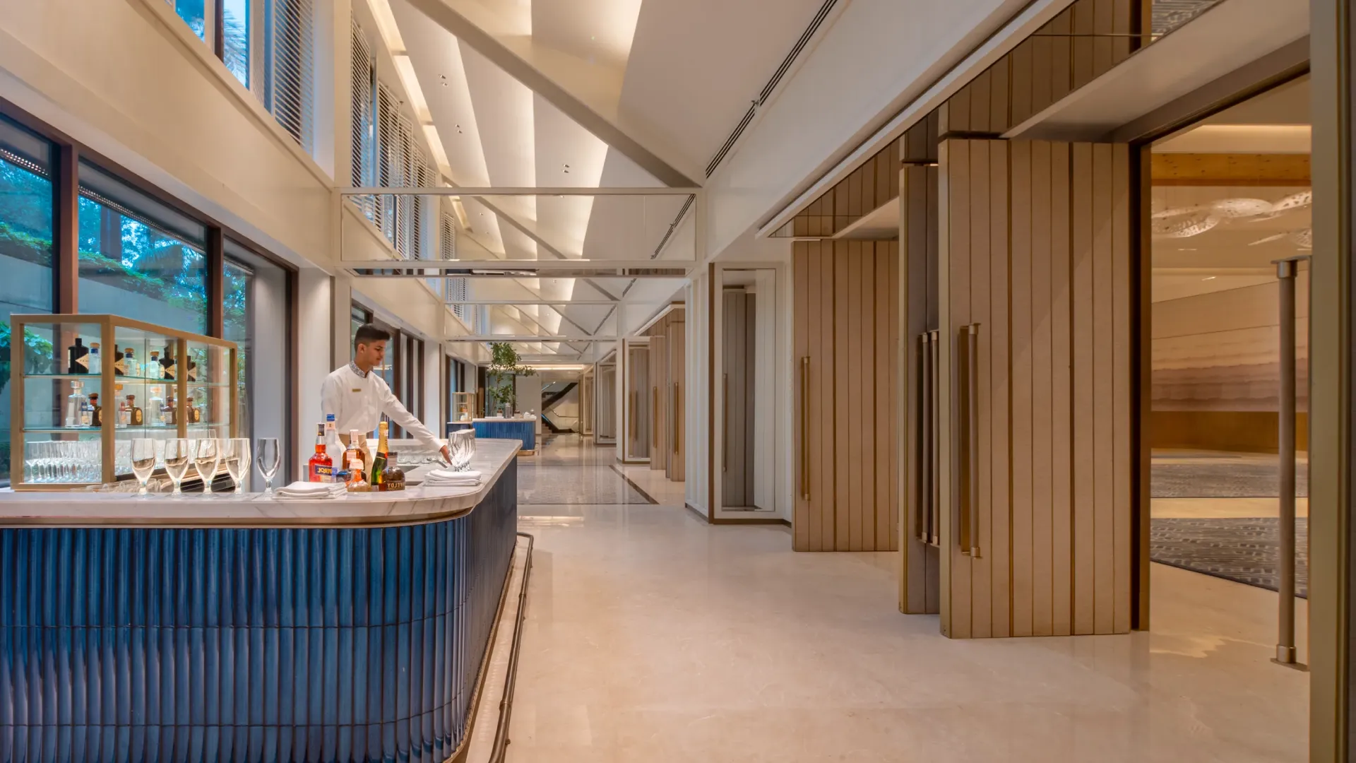 Pre-function area with a navy fluted bar and timber-panelled folding partitions at Trident, Nariman Point, Mumbai