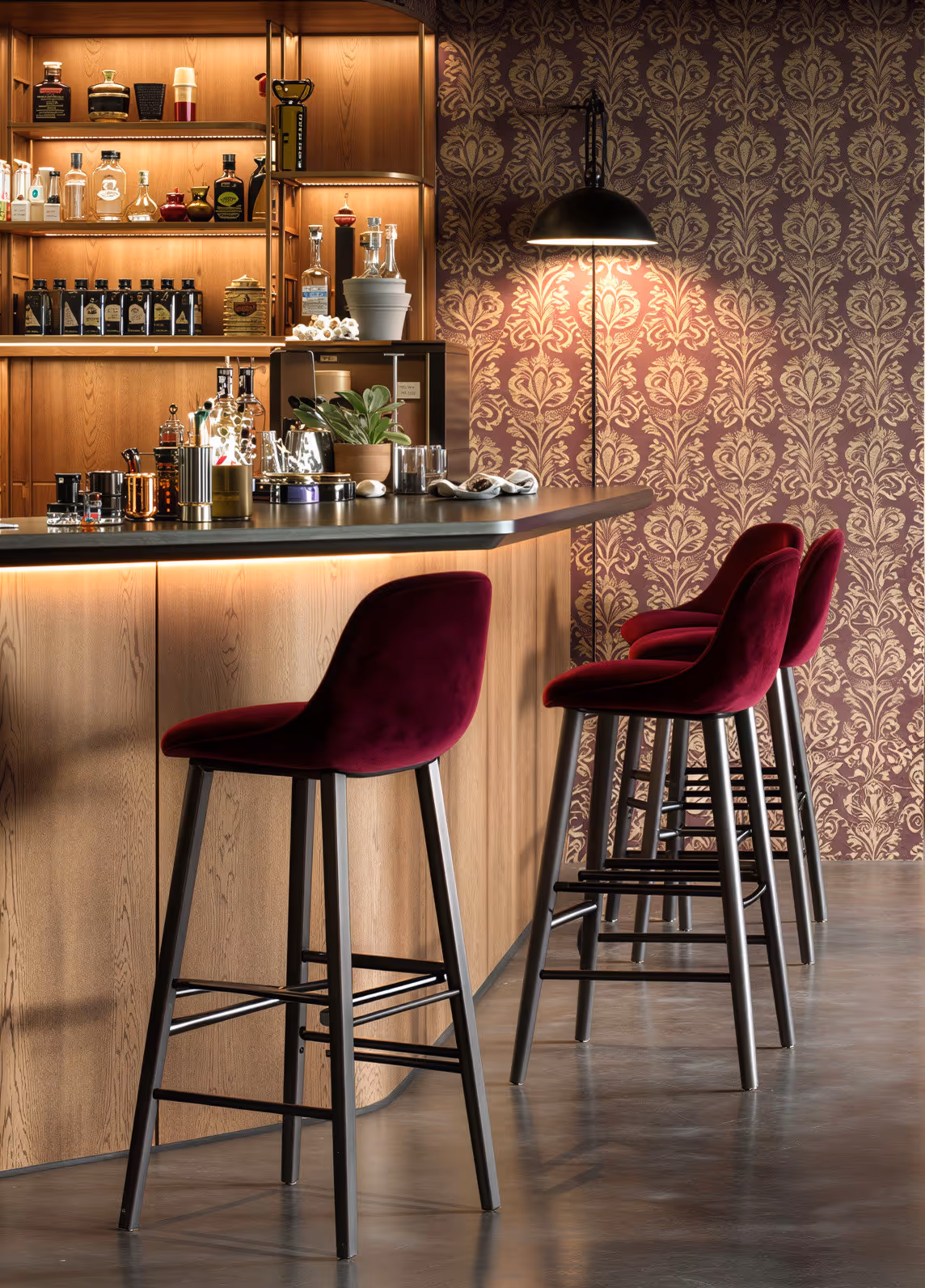 Bancone bar serale con sgabelli in velluto bordeaux, rovere retroilluminato e illuminazione d'atmosfera – design hospitality BMA