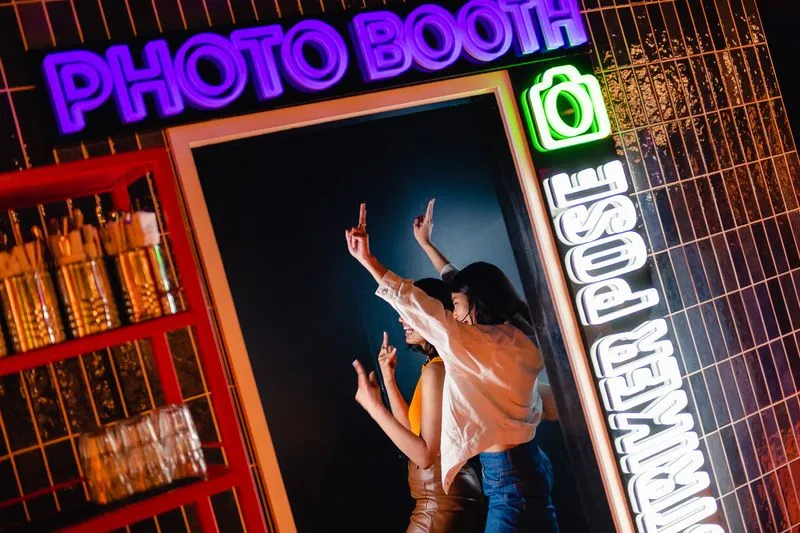 3 young women in a photobooth at TOCA Social