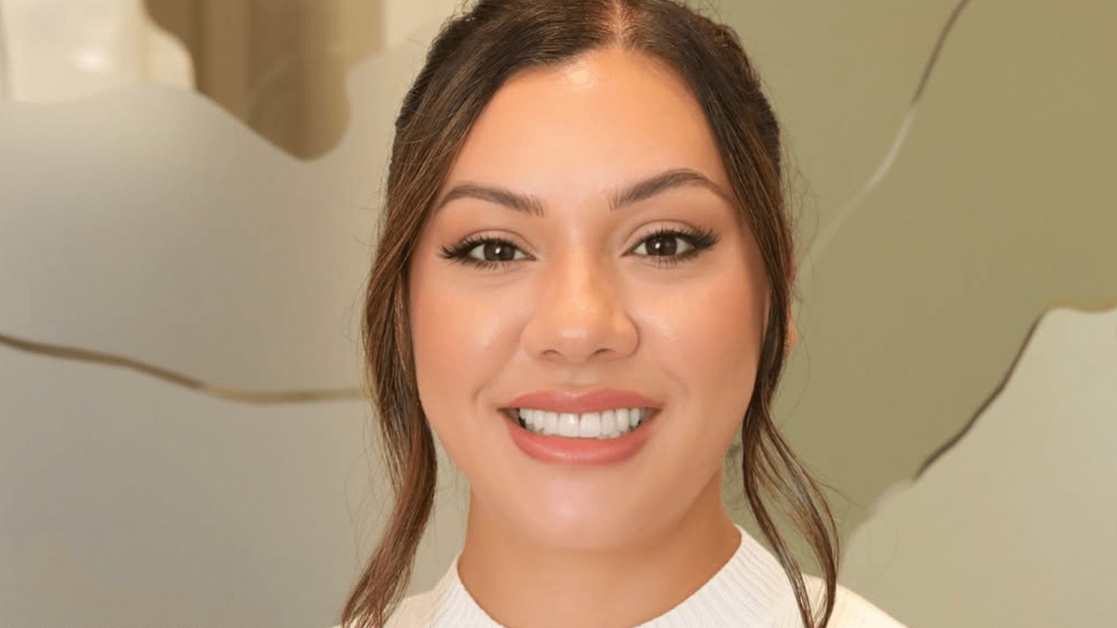 Woman with a bright, flawless smile showcasing porcelain veneers, demonstrating results from the best cosmetic dentist in San Francisco.