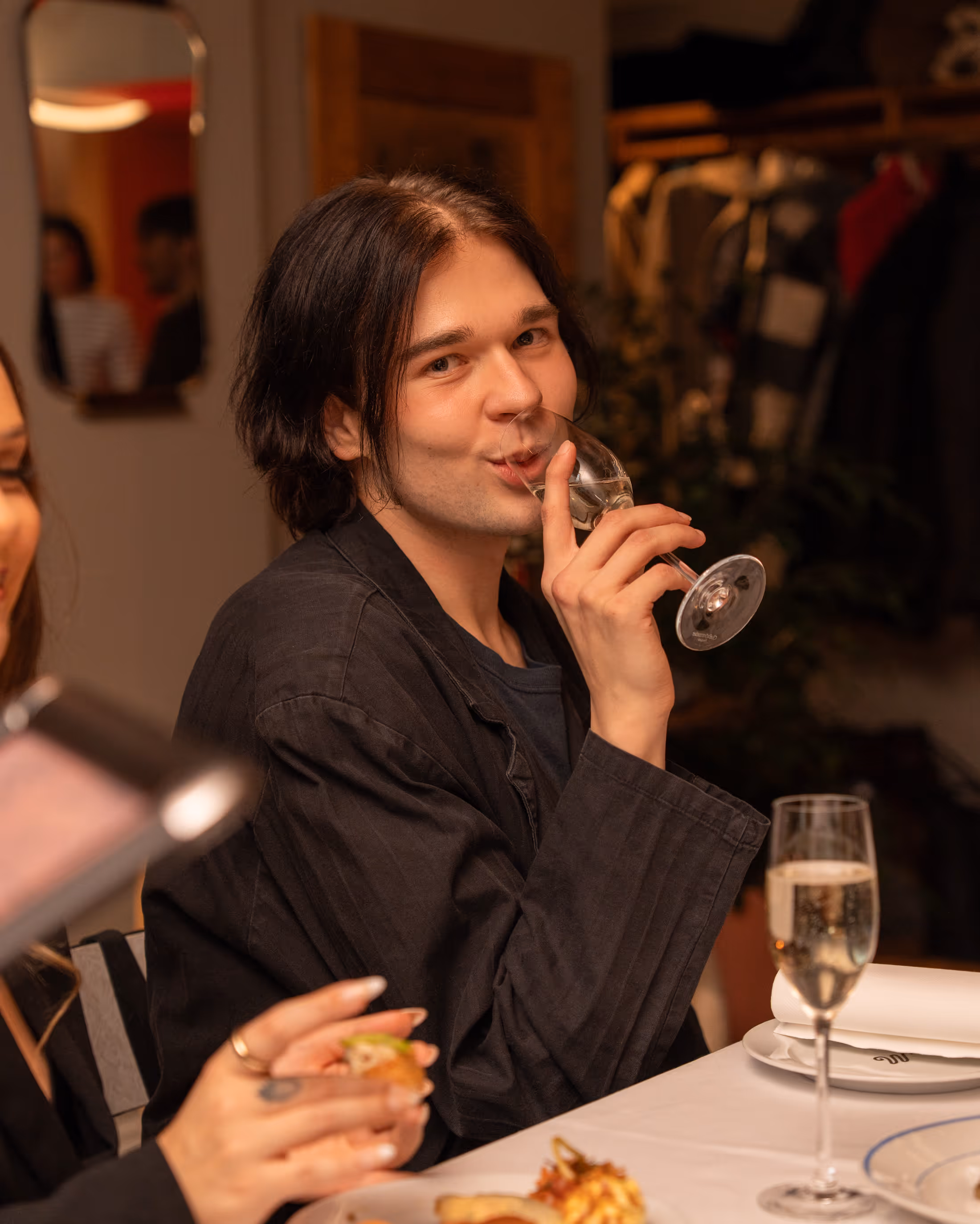 Guest enjoying a glass of sparkling wine at Restaurant Madame.