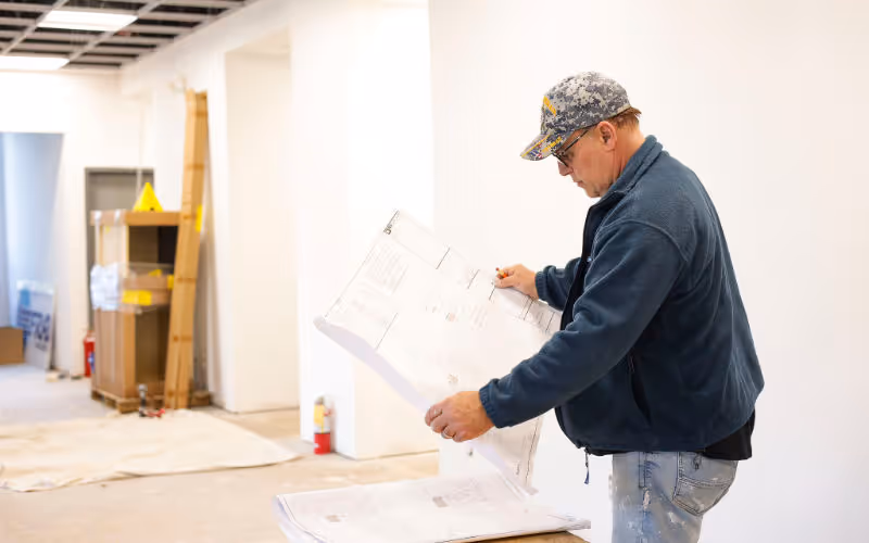 A man reading blueprints.