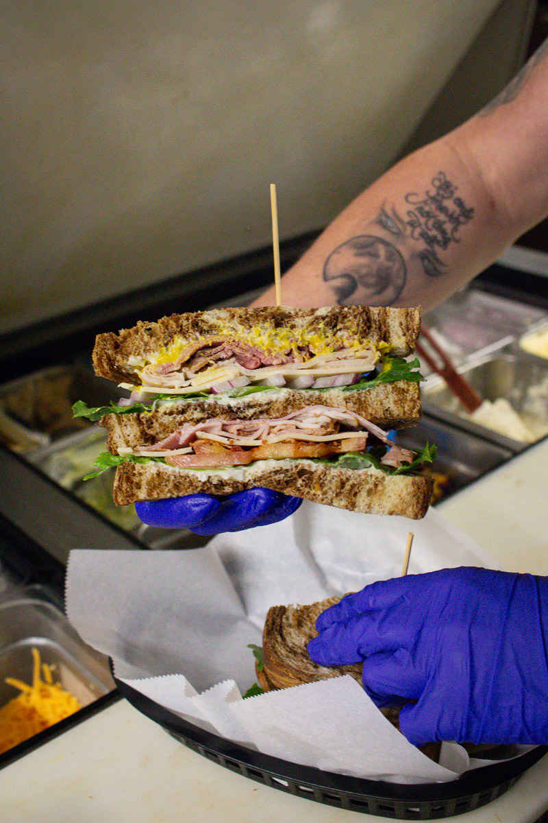 An employee preparing a sandwich.