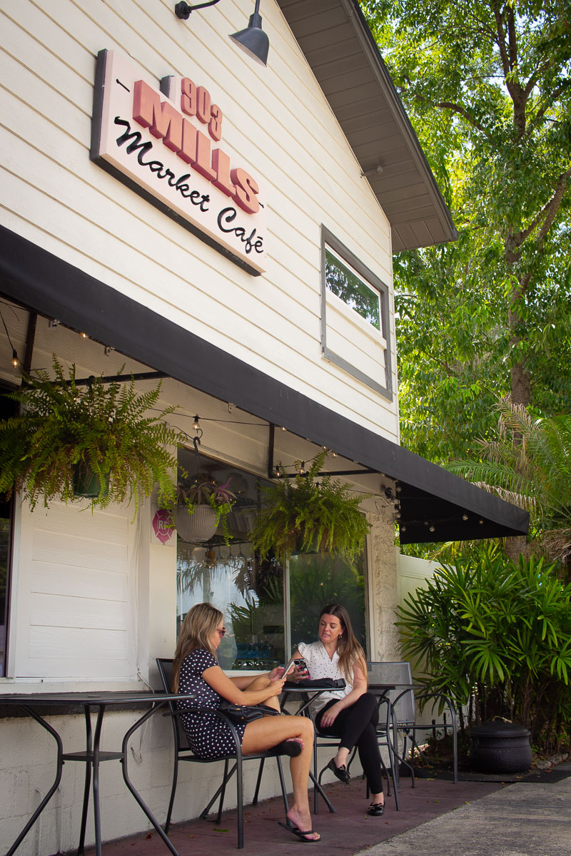 Two women sitting on the outside patio of 903 Mills Market.