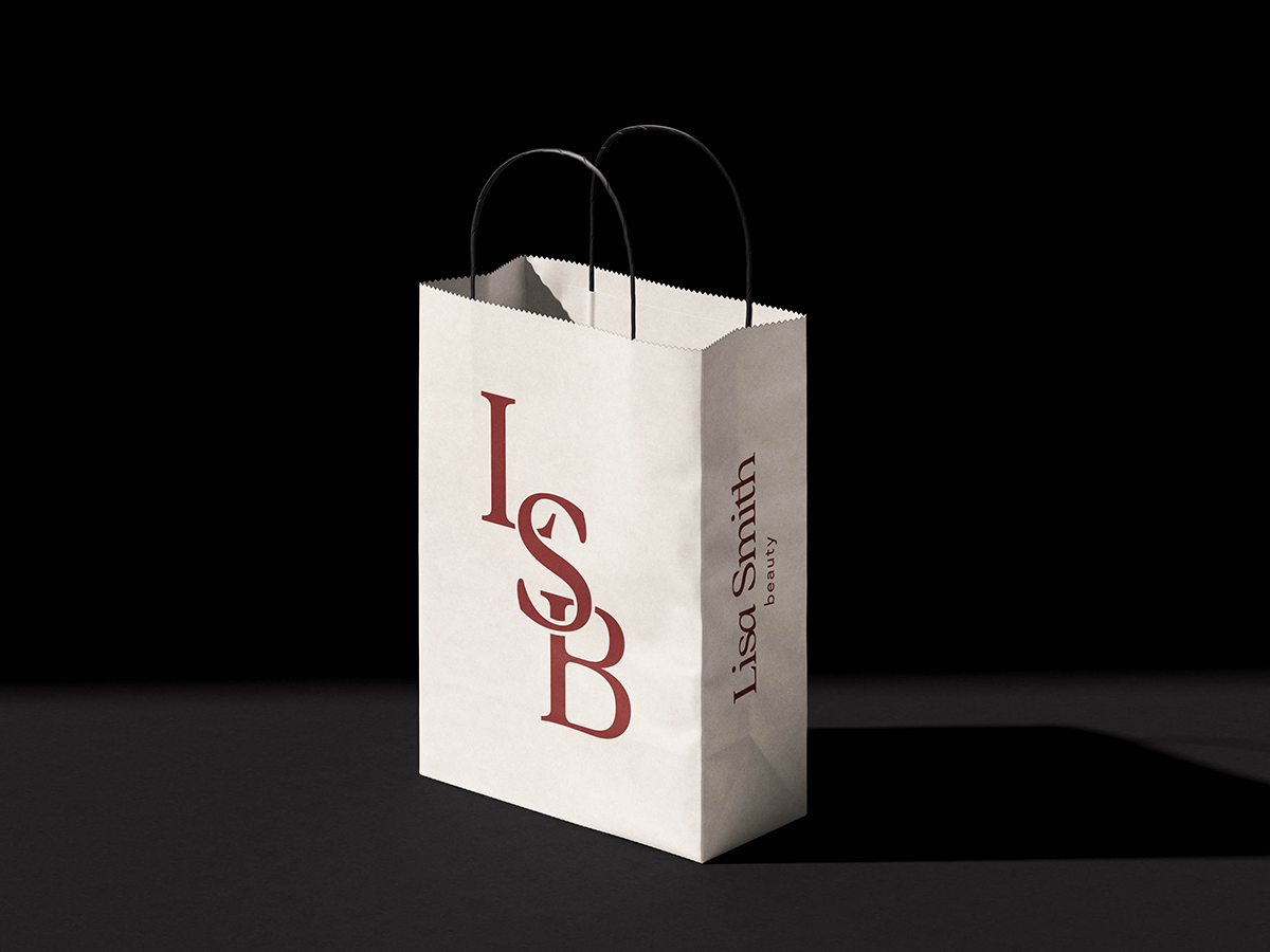 A cream bag with Lisa Smith Beauty's logos in red against a black background.